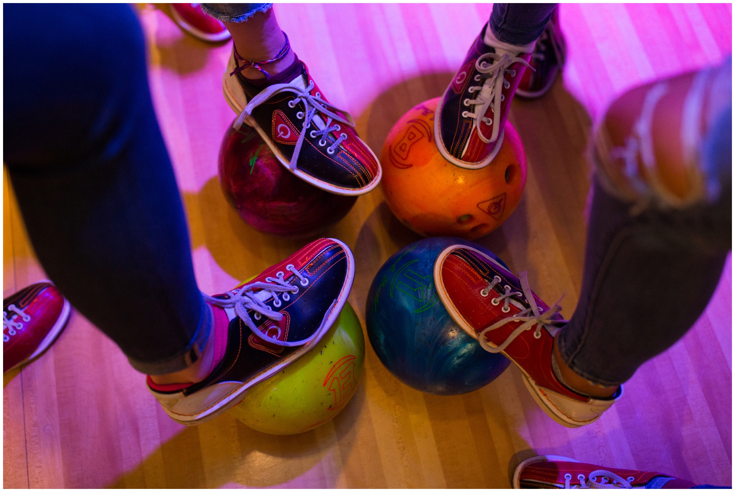 photo of feet resting on bowling balls 
