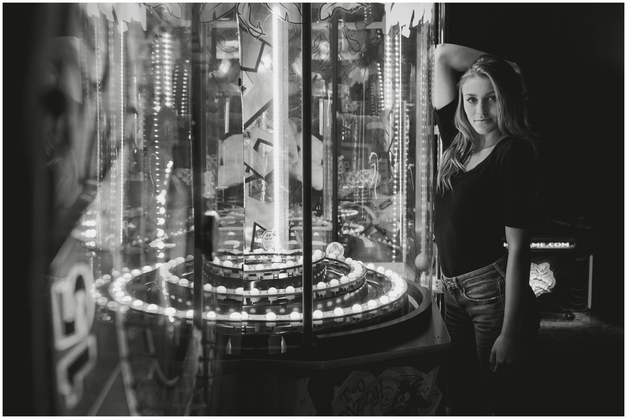 girl posing against game at arcade senior pictures