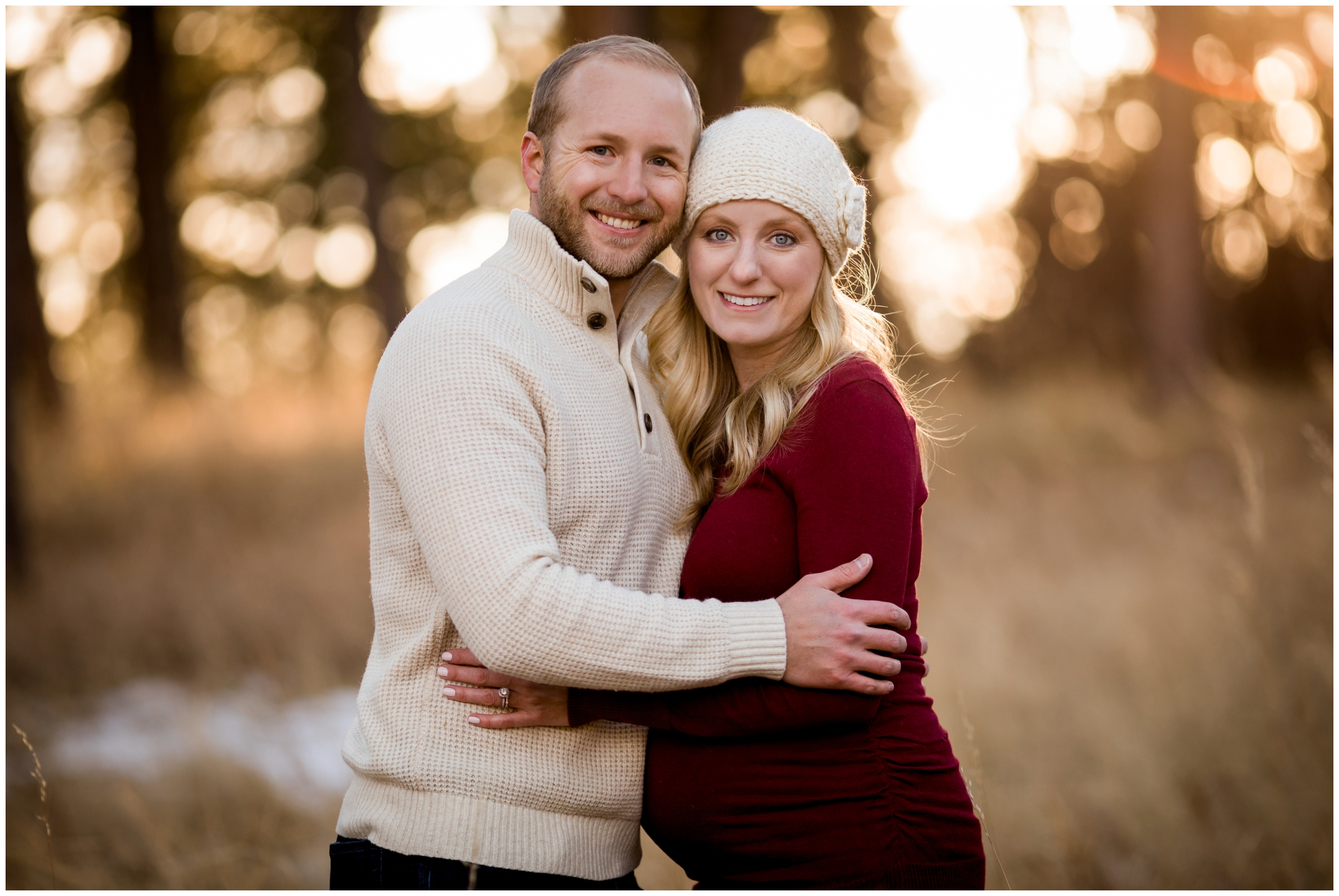 couple smiling at camera during Colorado maternity pictures 