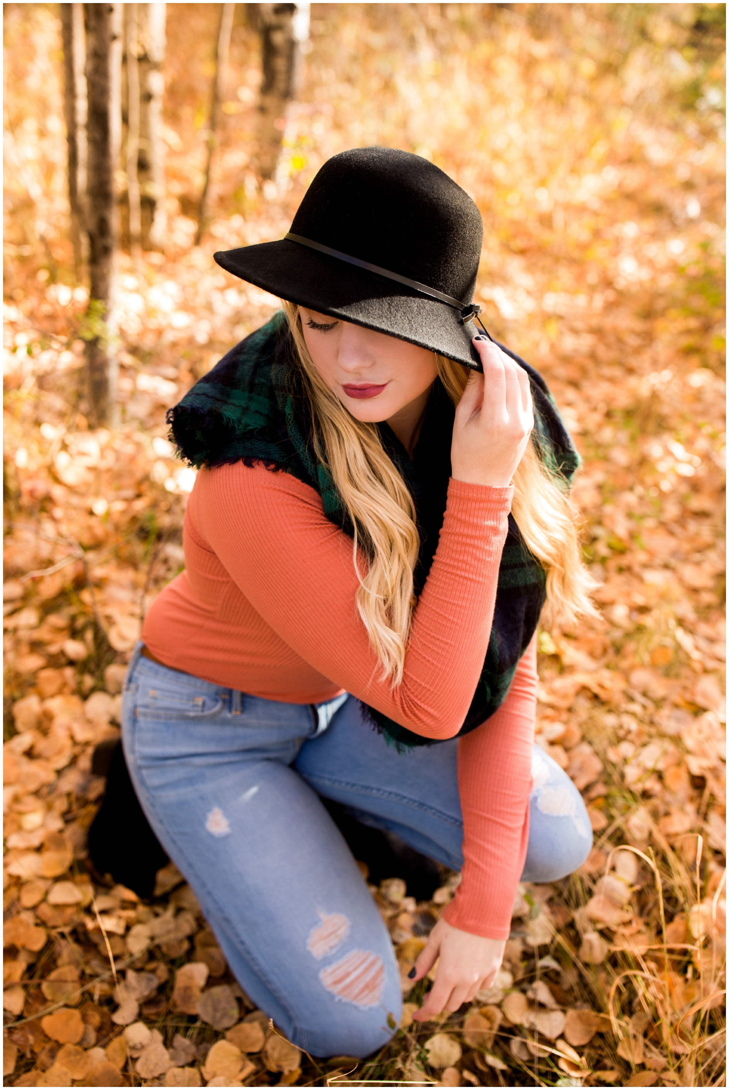 teen girl surrounded by fall leaves at Gross reservoir Colorado senior photos