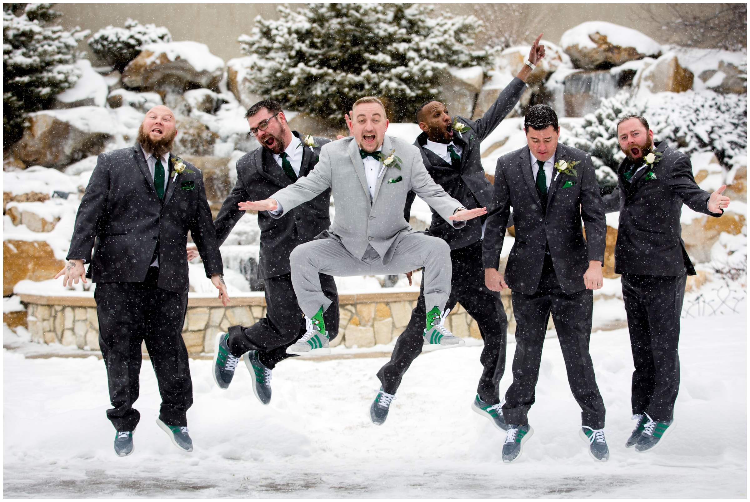 groomsmen jumping in snow during Castle Rock Colorado winter wedding 