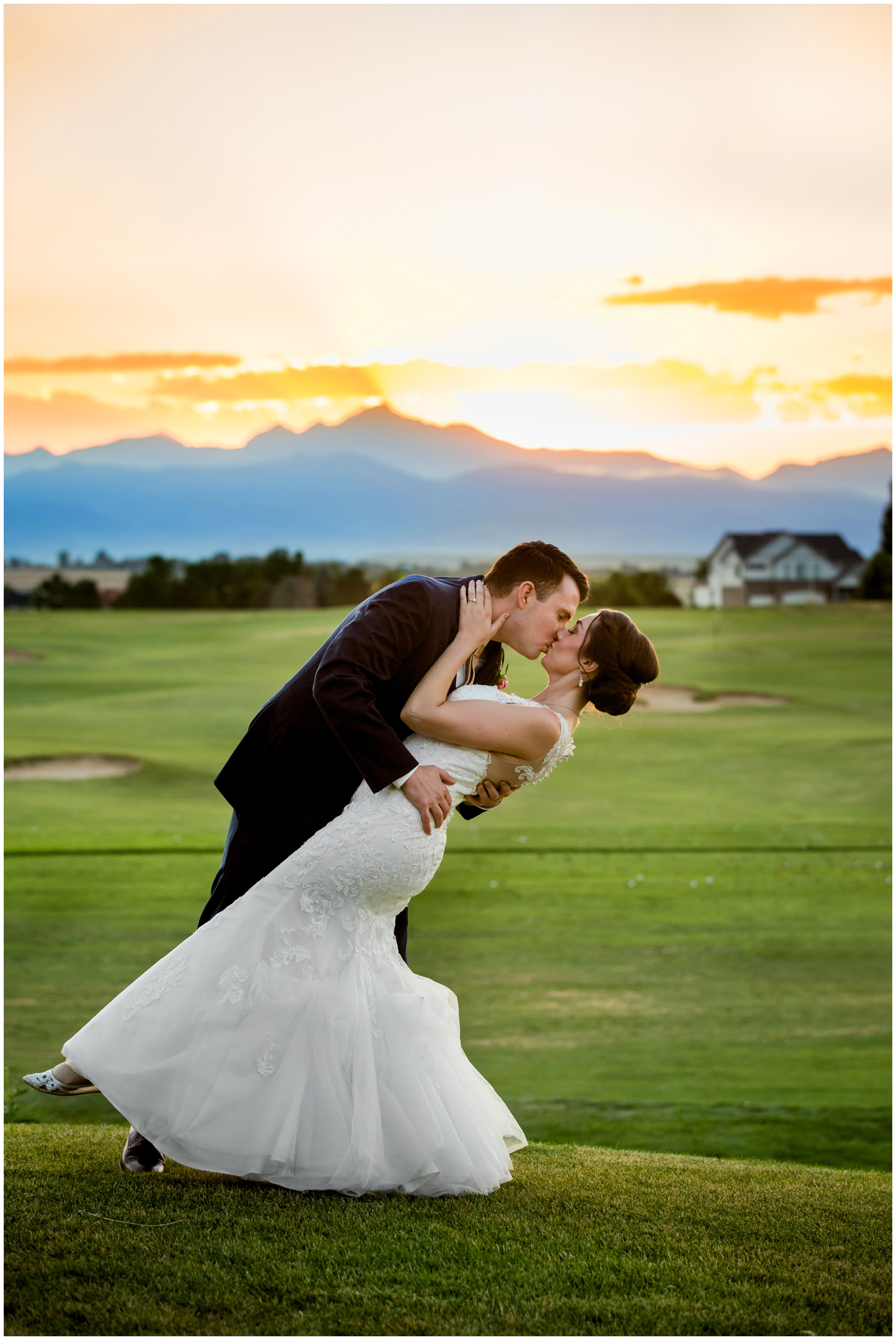 couple kissing with mountains and sunset in background during Denver Colorado golf course wedding photography session