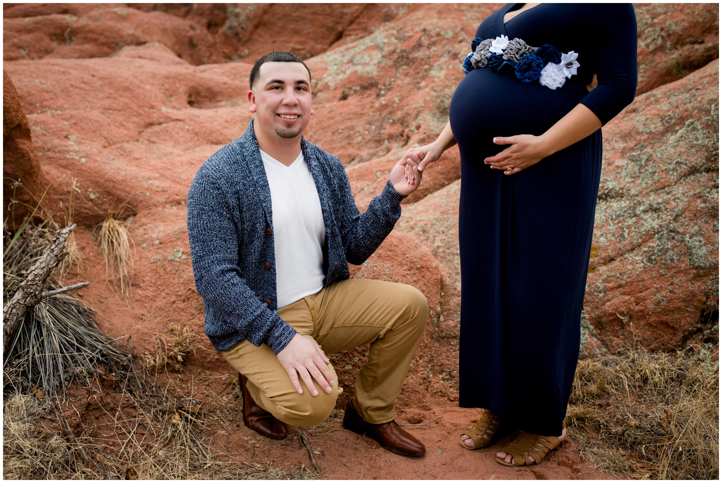 pregnant woman and husband holding hands at Garden of the Gods Park