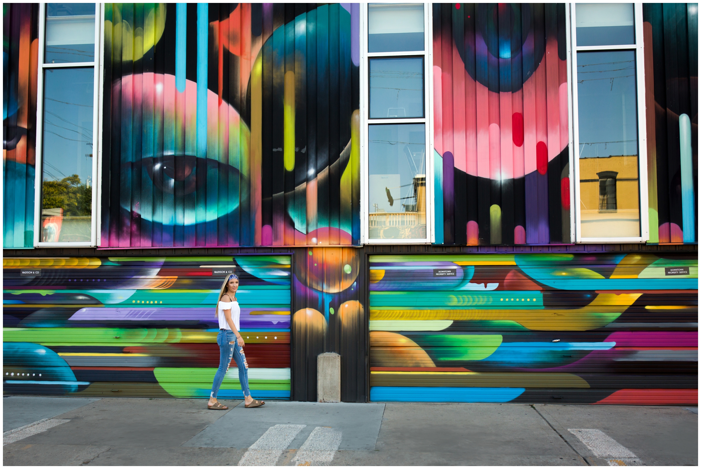 girl walking in front of colorful mural in downtown Denver 