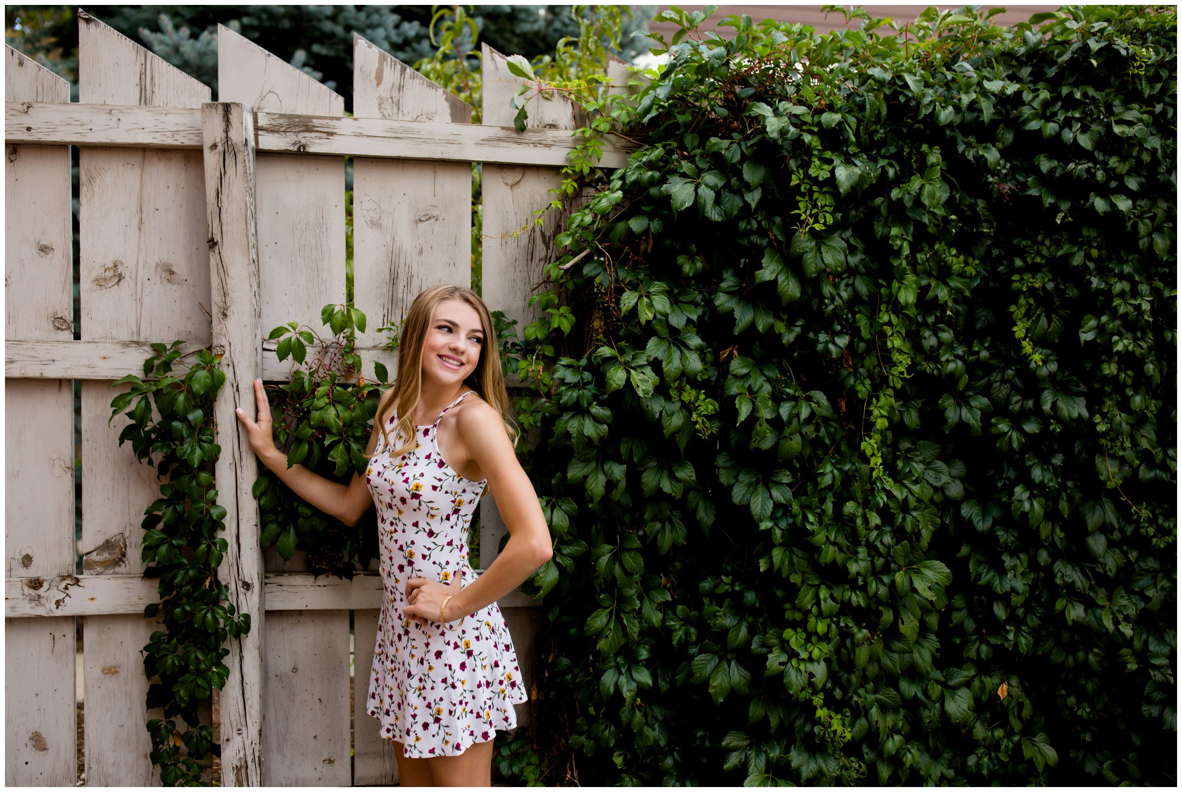 teen posing against ivy wall at Frederick Colorado senior photography session 