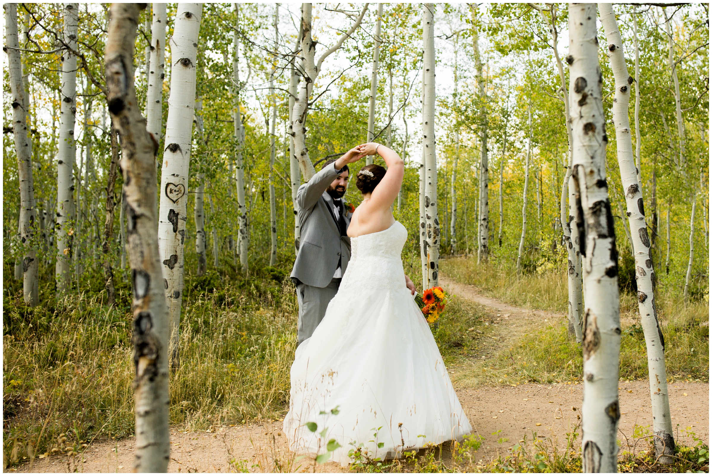 groom spinning bride in aspen grove at Granby Colorado summer wedding