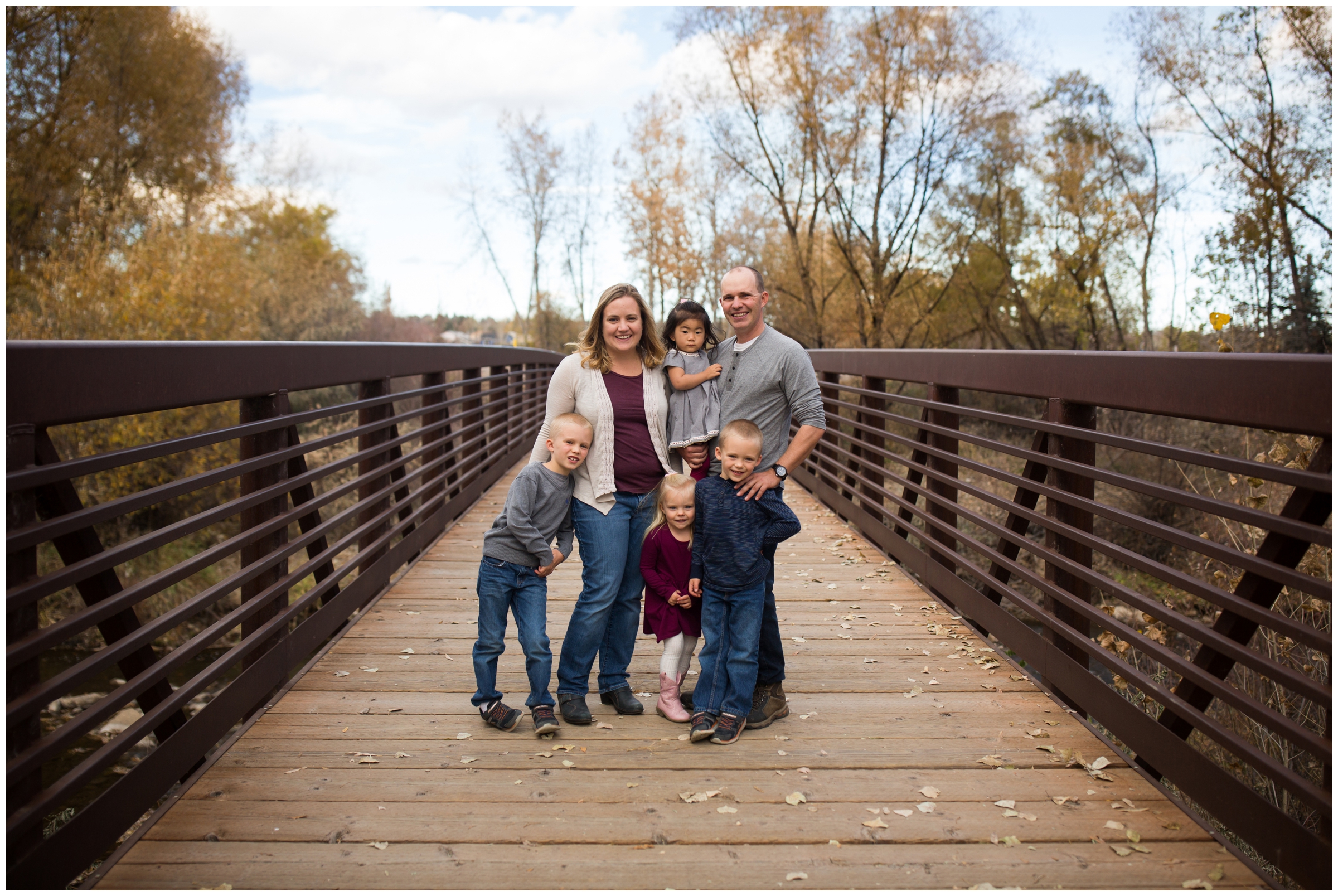 family posing on bridge during Golden Ponds Longmont family pictures 