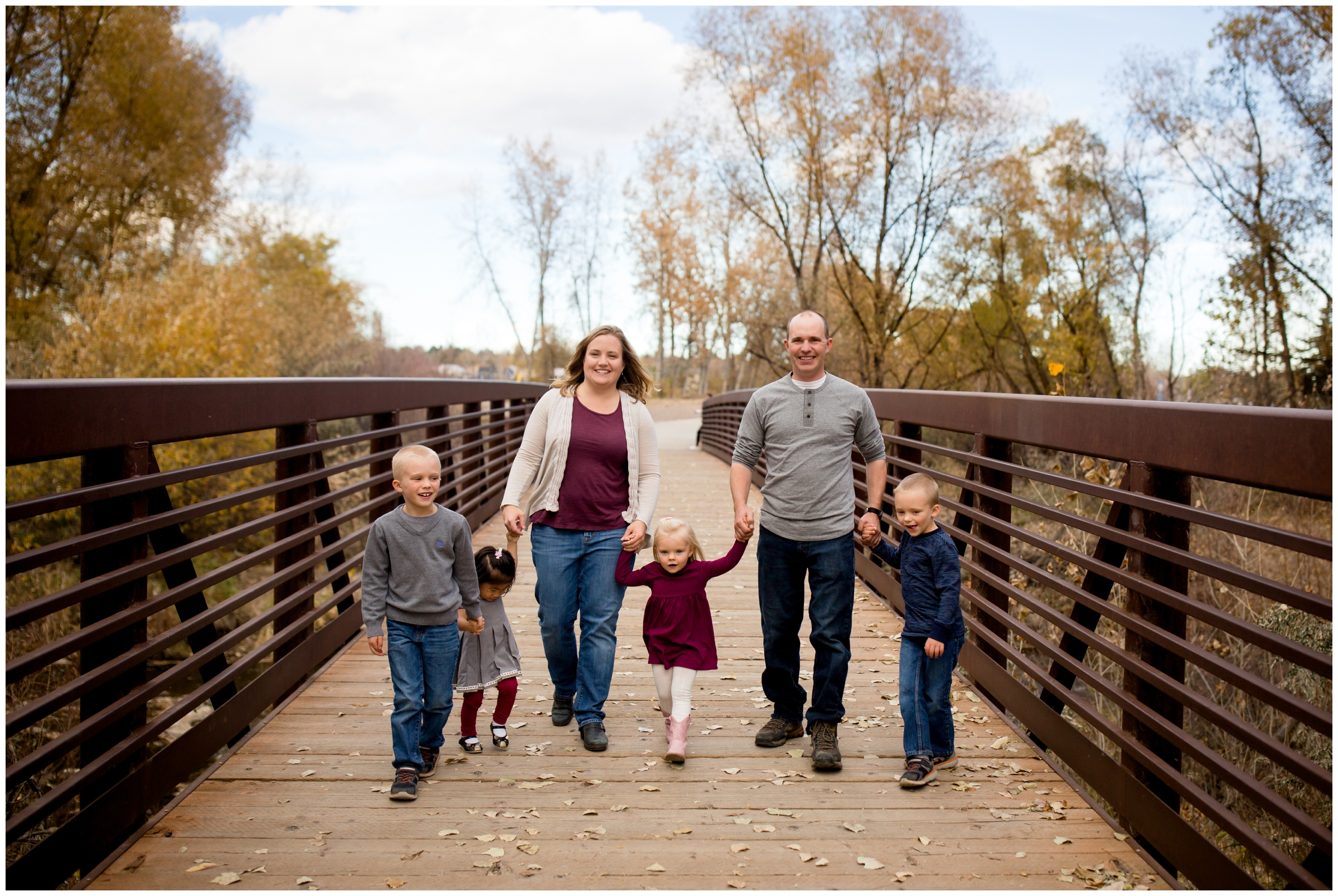 family walking on bridge at Golden Ponds Nature Area