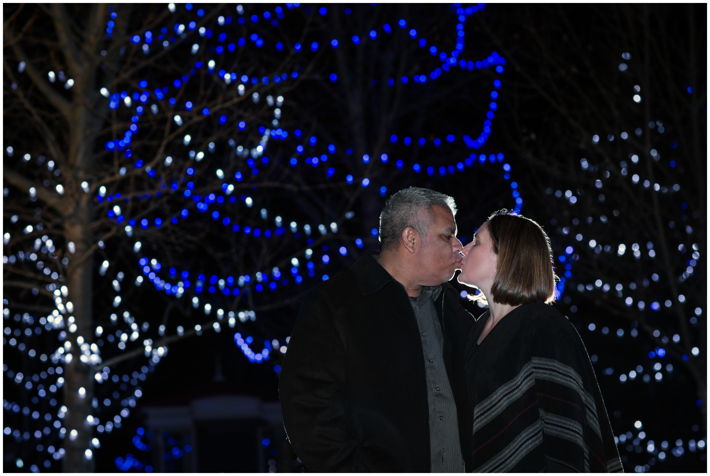 couple kissing under holiday lights at Chapungu Sculpture Garden 