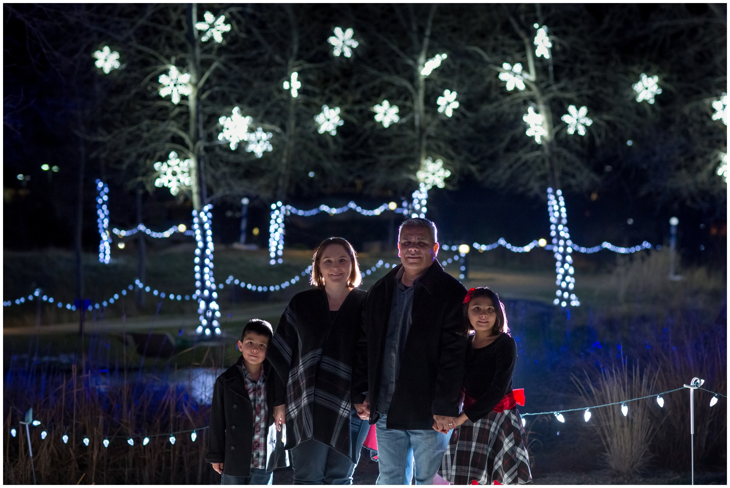 nighttime Loveland Colorado family pictures at Winter Wonderlights at Chapungu Sculpture Garden