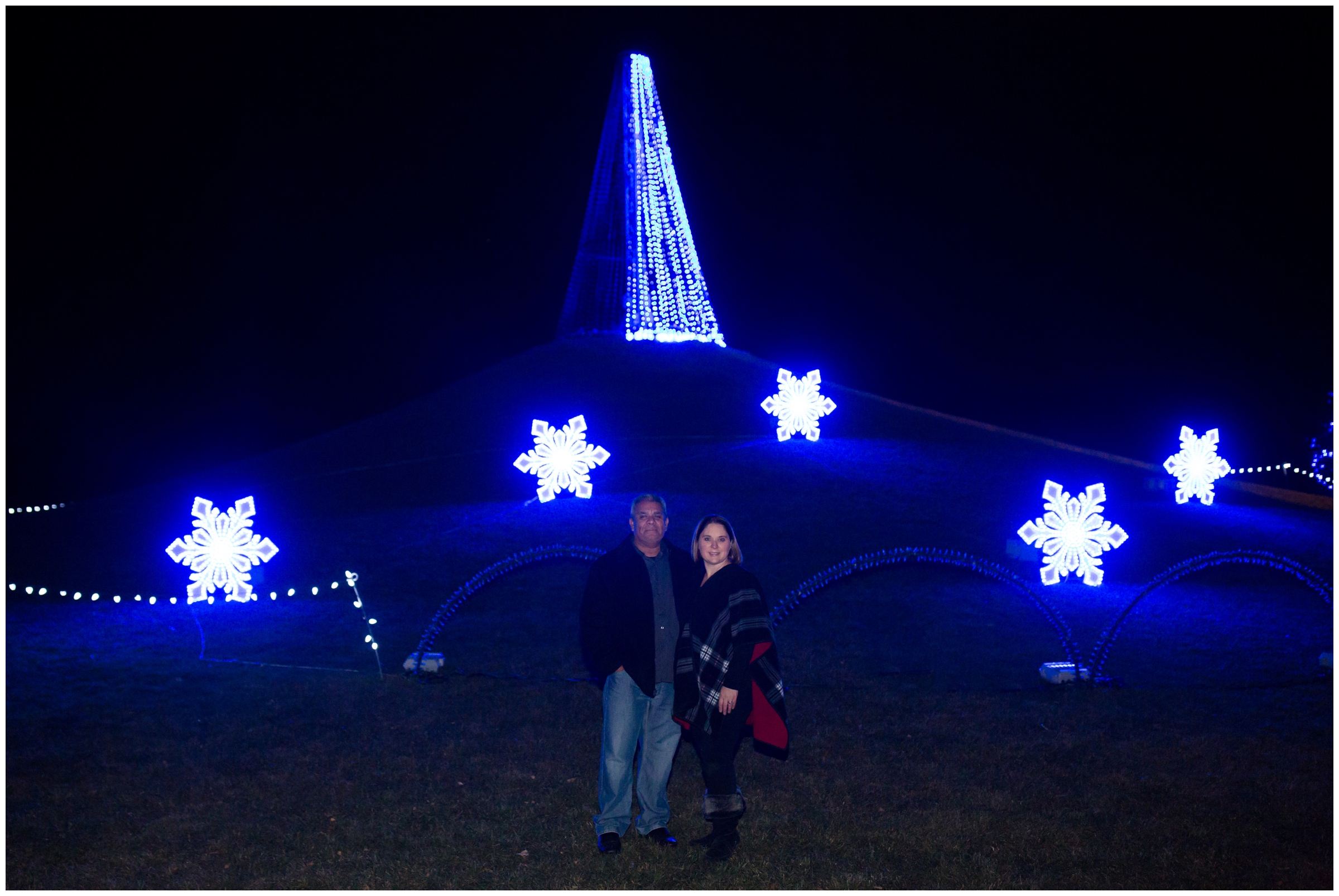 couple standing in front of christmas tree at Winter Wonderlights in CO