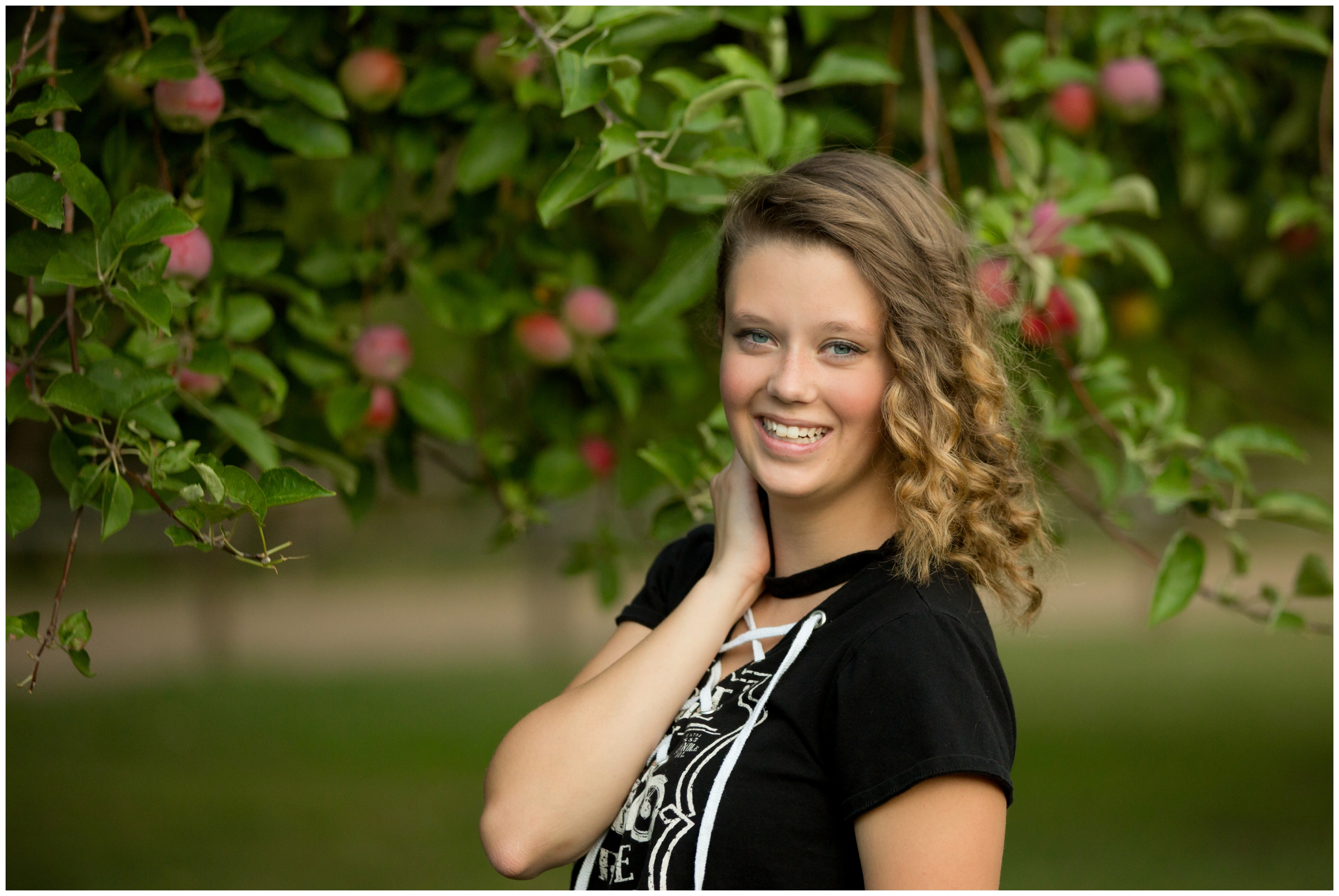 teen posing with apple trees in background at Bobcat Ridge Loveland 