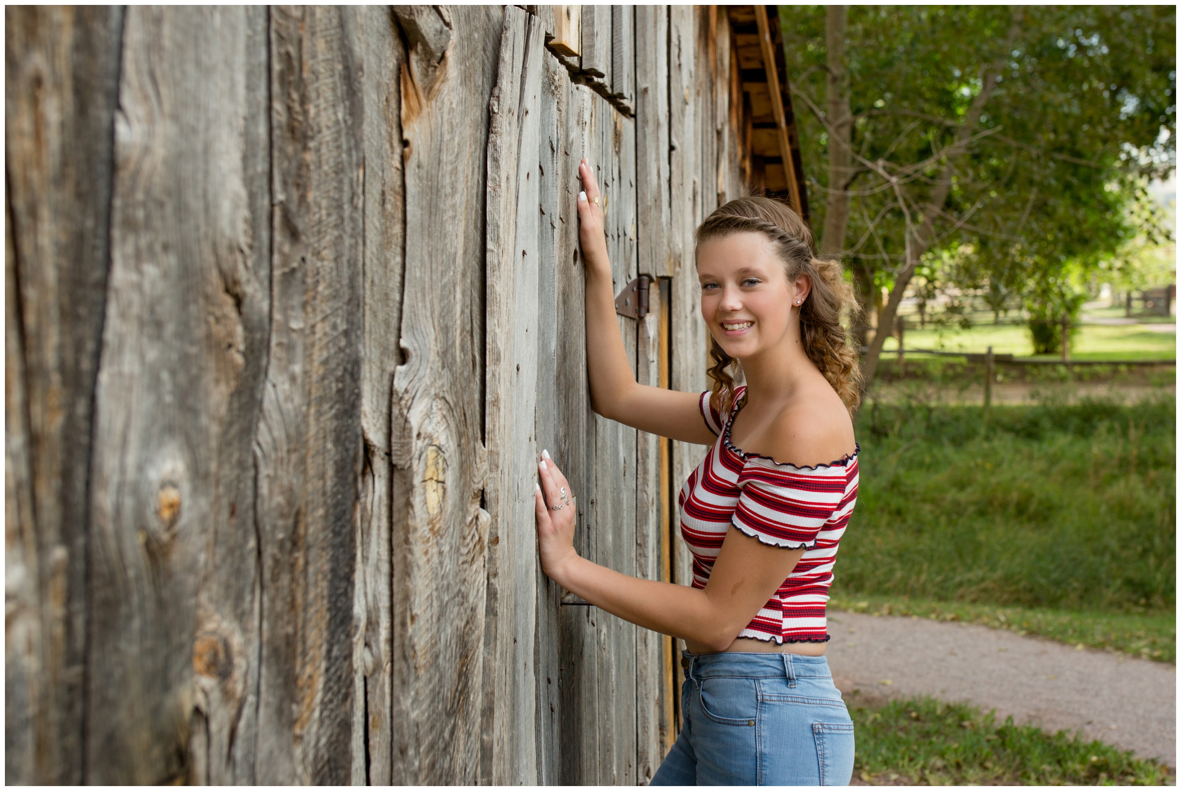 girl leaning against barn at Bobcat Ridge Nature Area Ft. Collins 