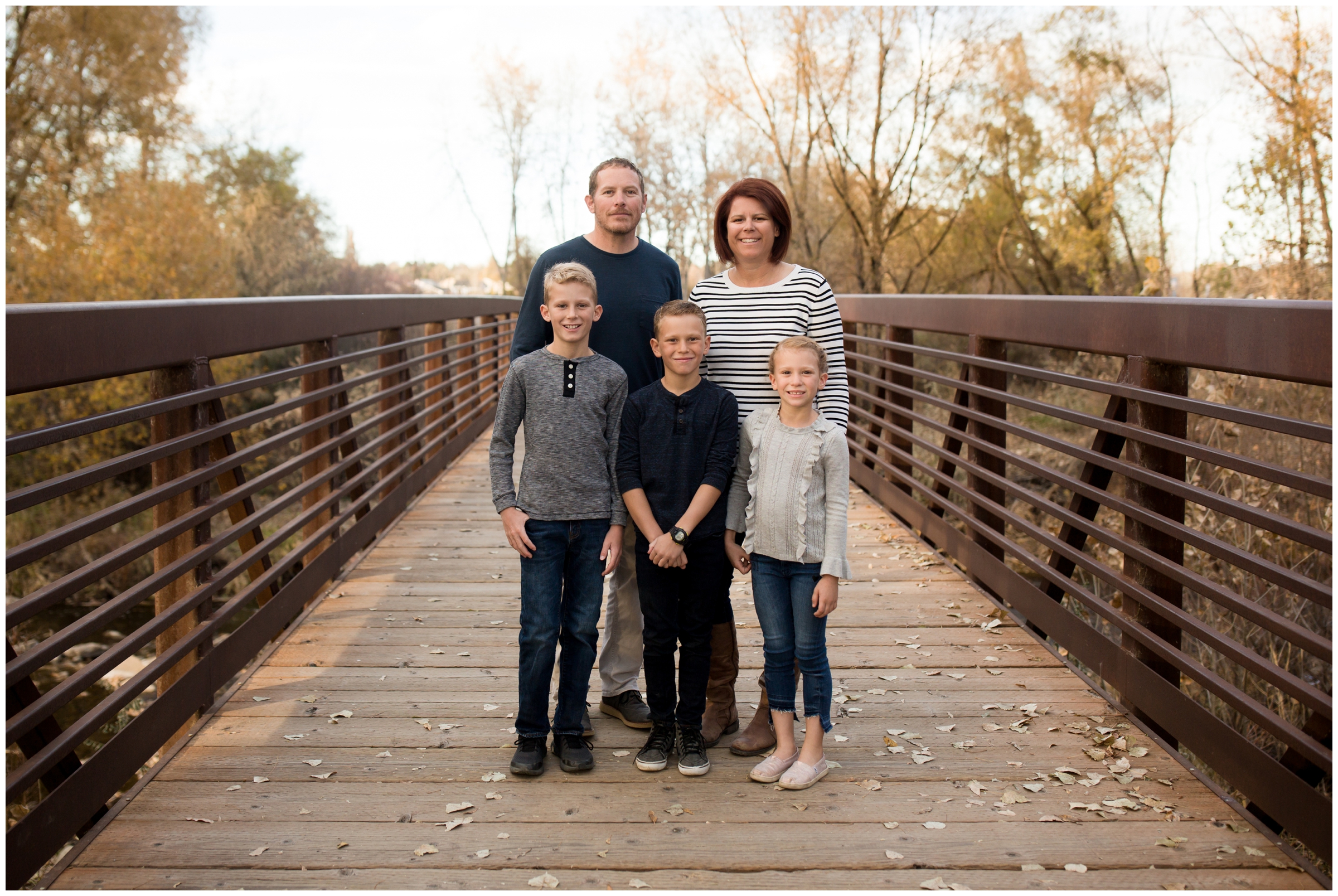 family posing on bridge during Boulder Colorado fall family portraits 