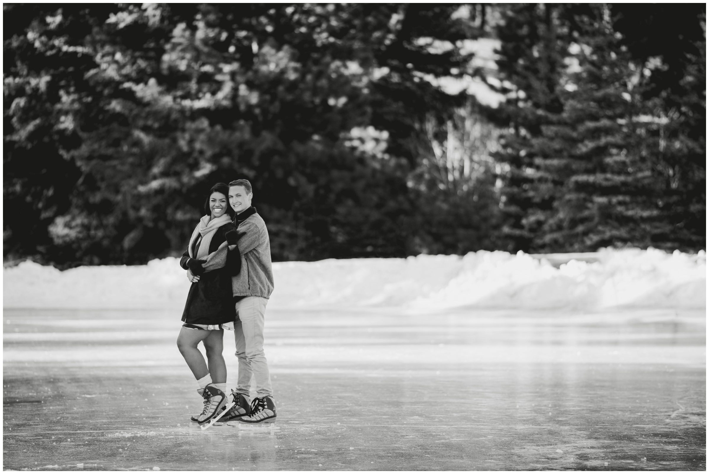 Couple ice skating at Dorsey Lake YMCA of the Rockies during Estes Park engagement portraits 