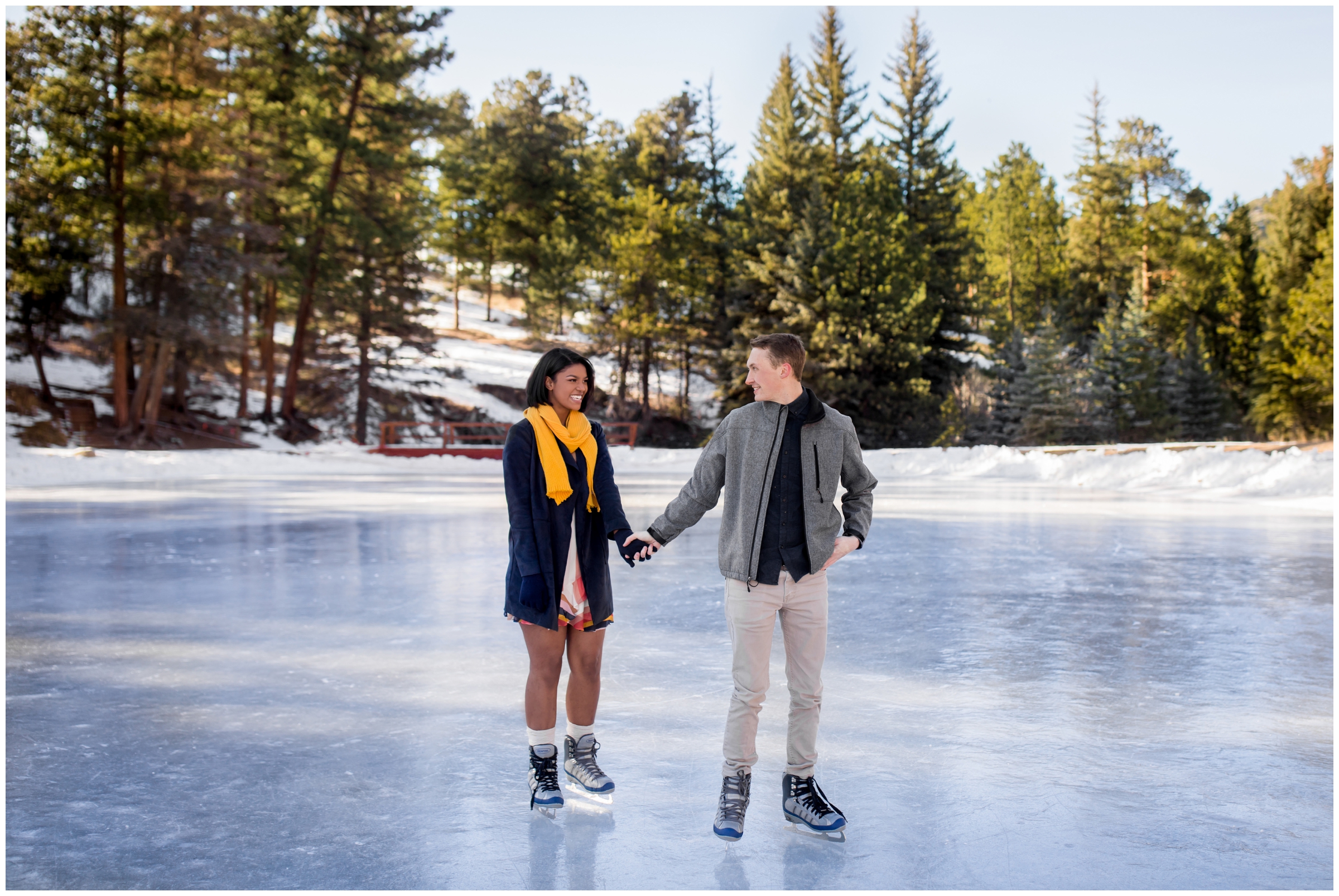 couple ice skating at Dorsey Lake Estes Park during Colorado winter engagement photography session 