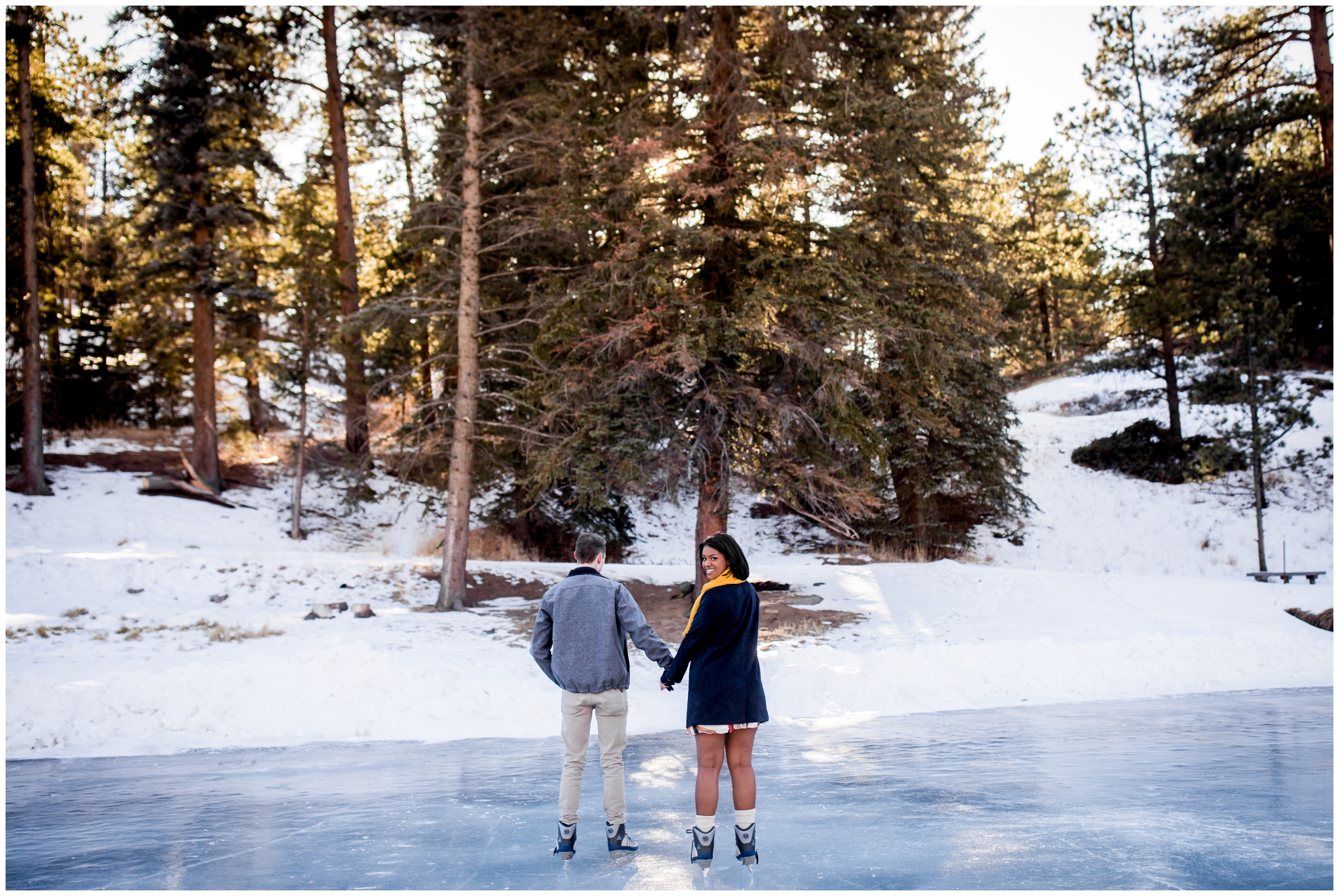 couple ice skating on frozen lake in Colorado mountains during Estes Park engagement pictures 