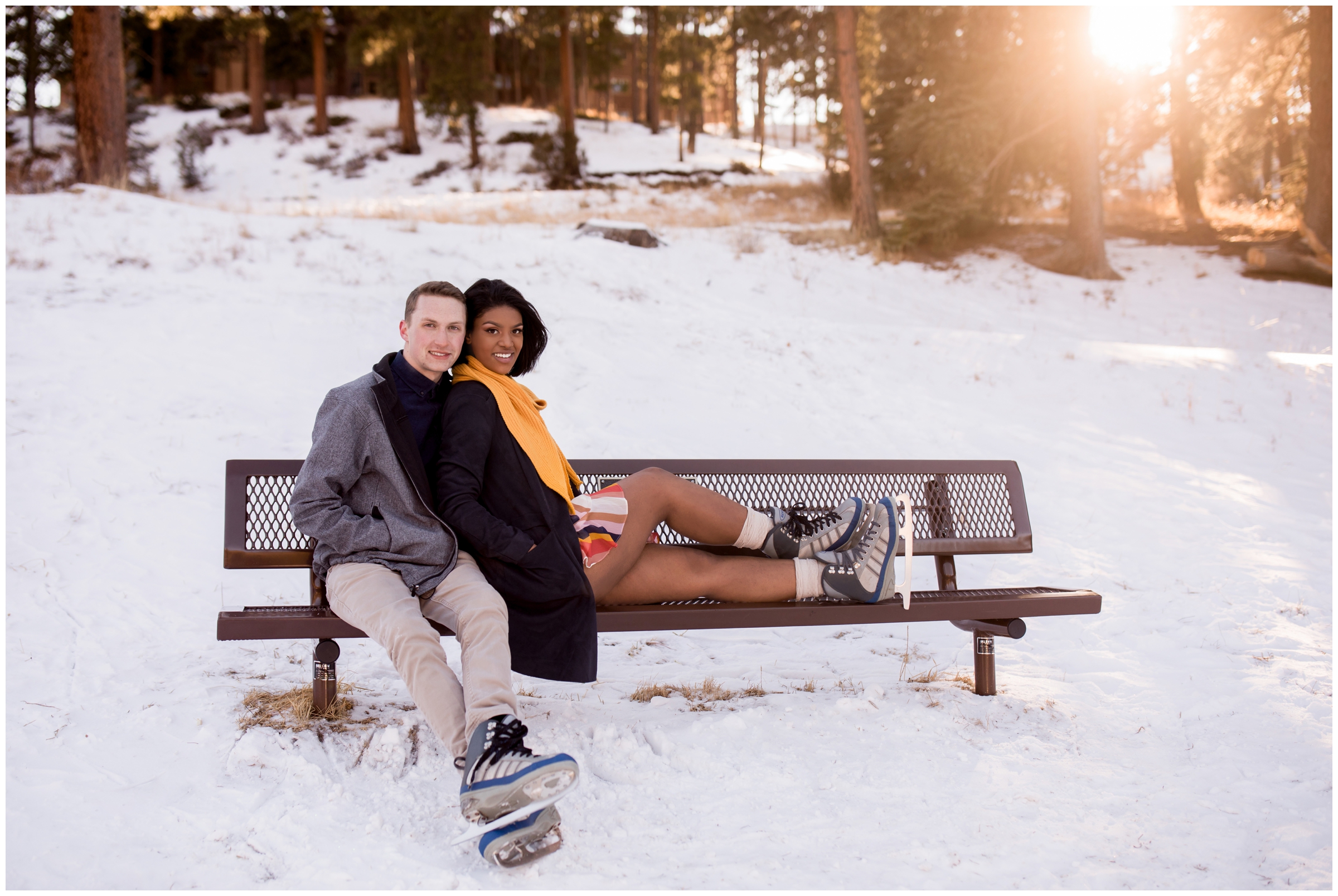 couple posing on a bench with ice skates on during Estes Park Colorado winter engagement pictures 