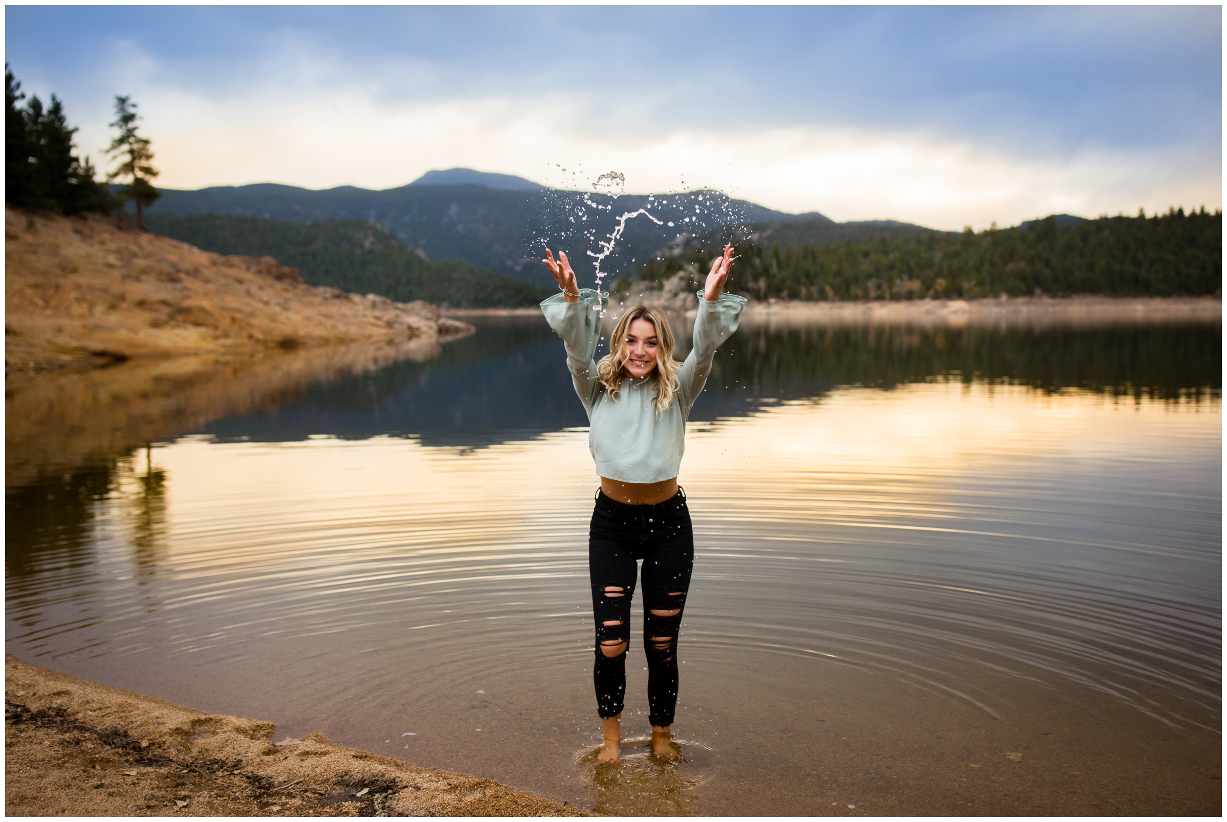 teen girl throwing water towards camera at Gross Reservoir Nederland Colorado 