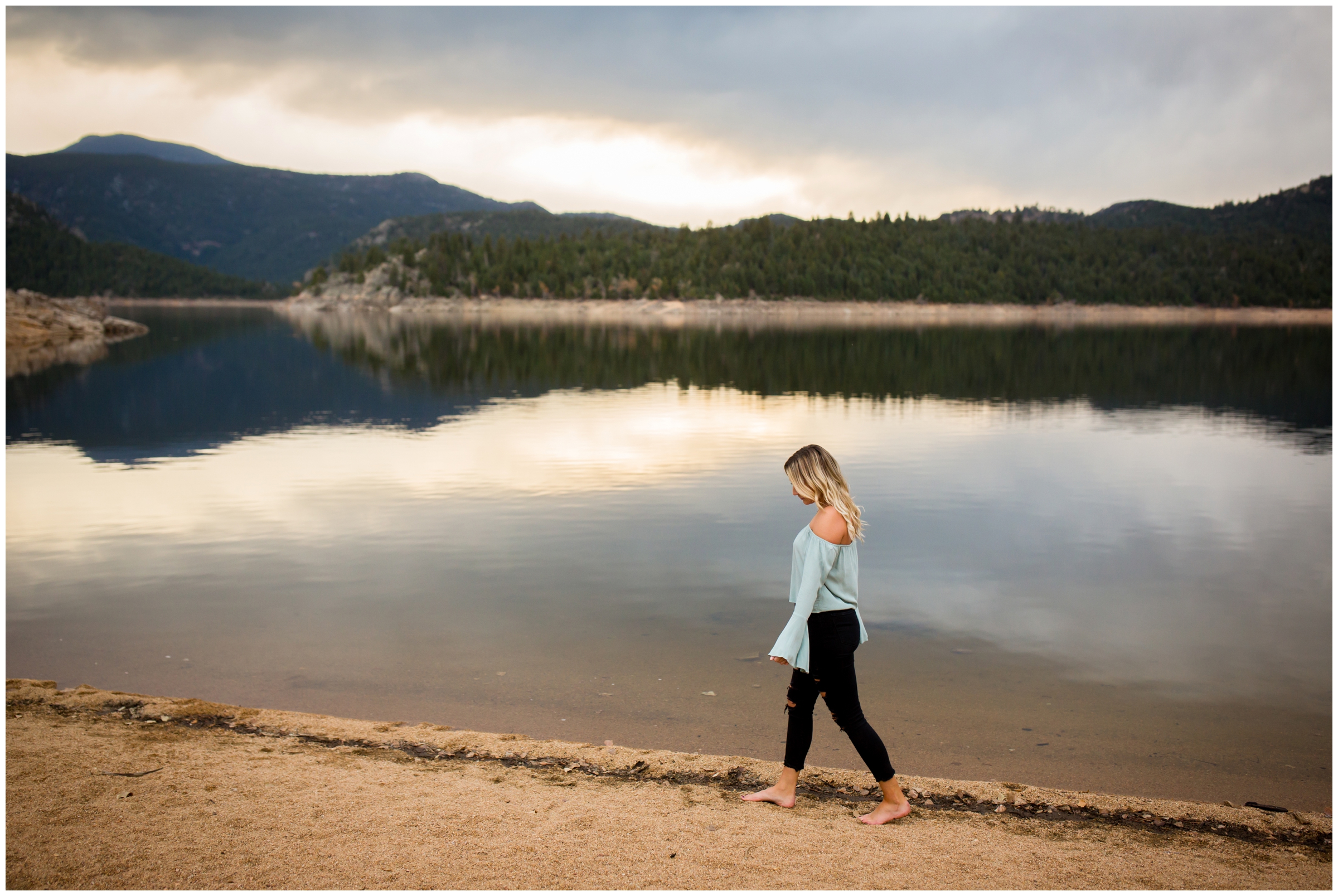 teen girl walking in a lake during Colorado mountain senior pictures at Gross Reservoir 