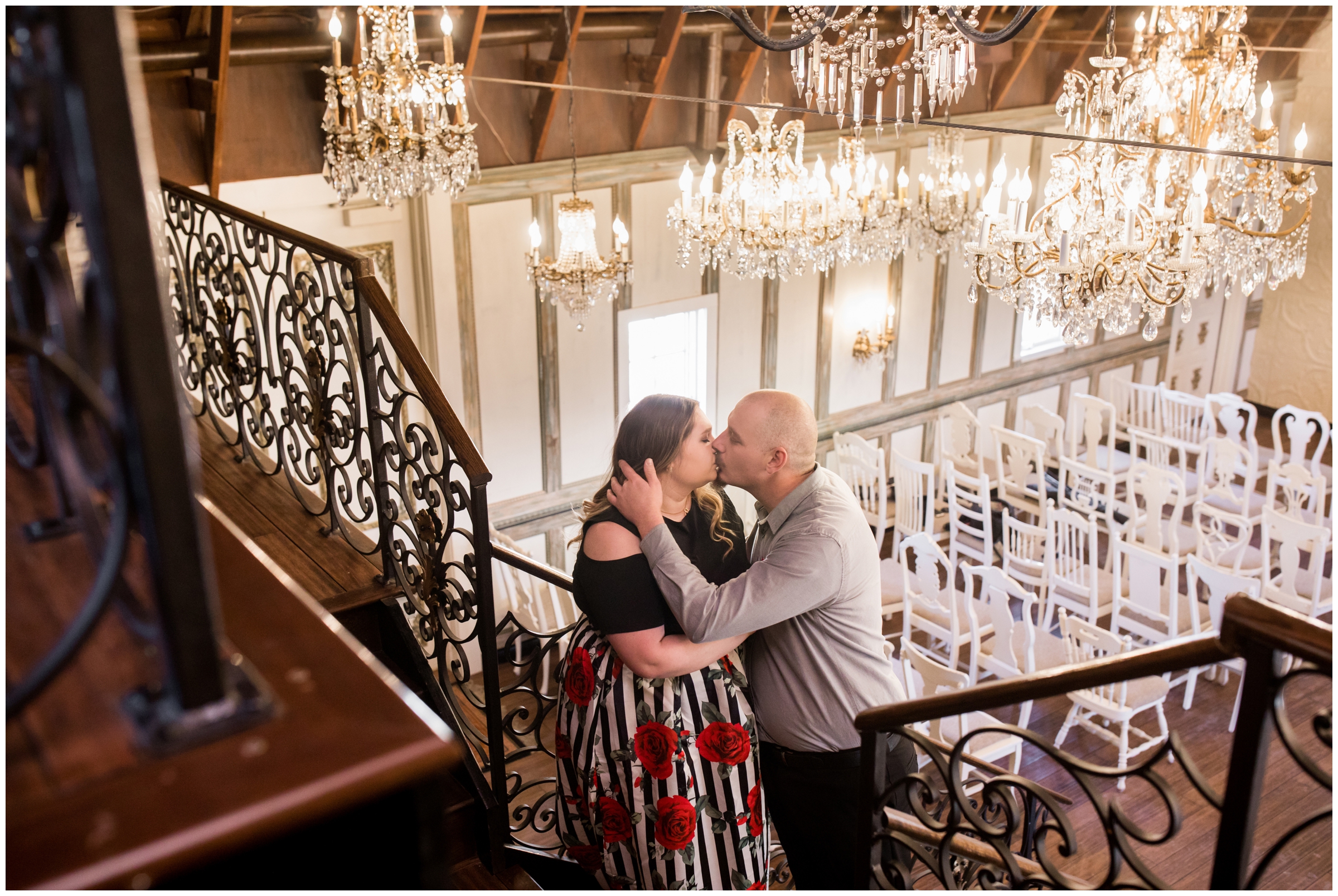 couple kissing in Chandelier Barn during Colorado winter engagement photos