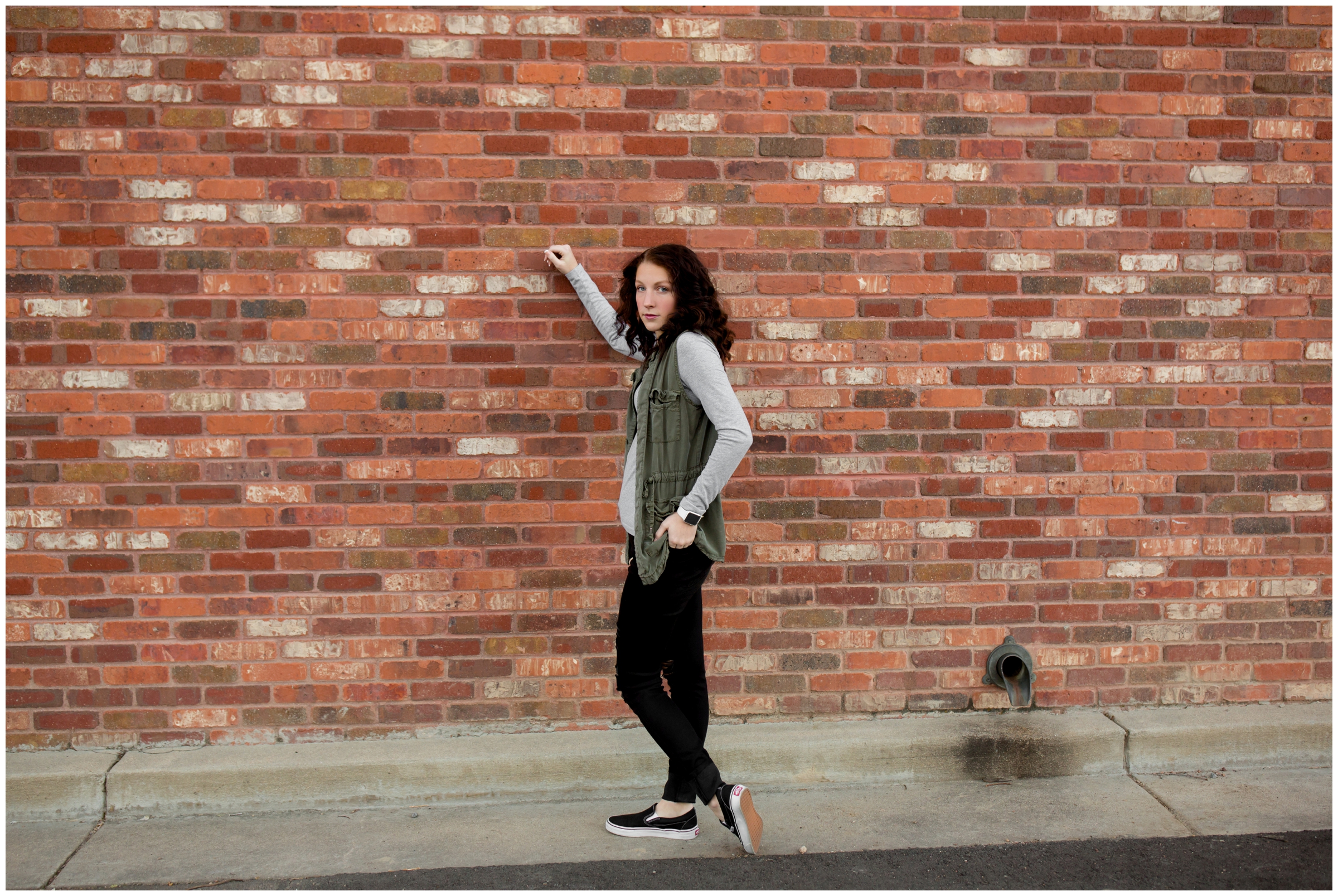 high school student leaning against a brick wall during Niwot Colorado senior portraits 