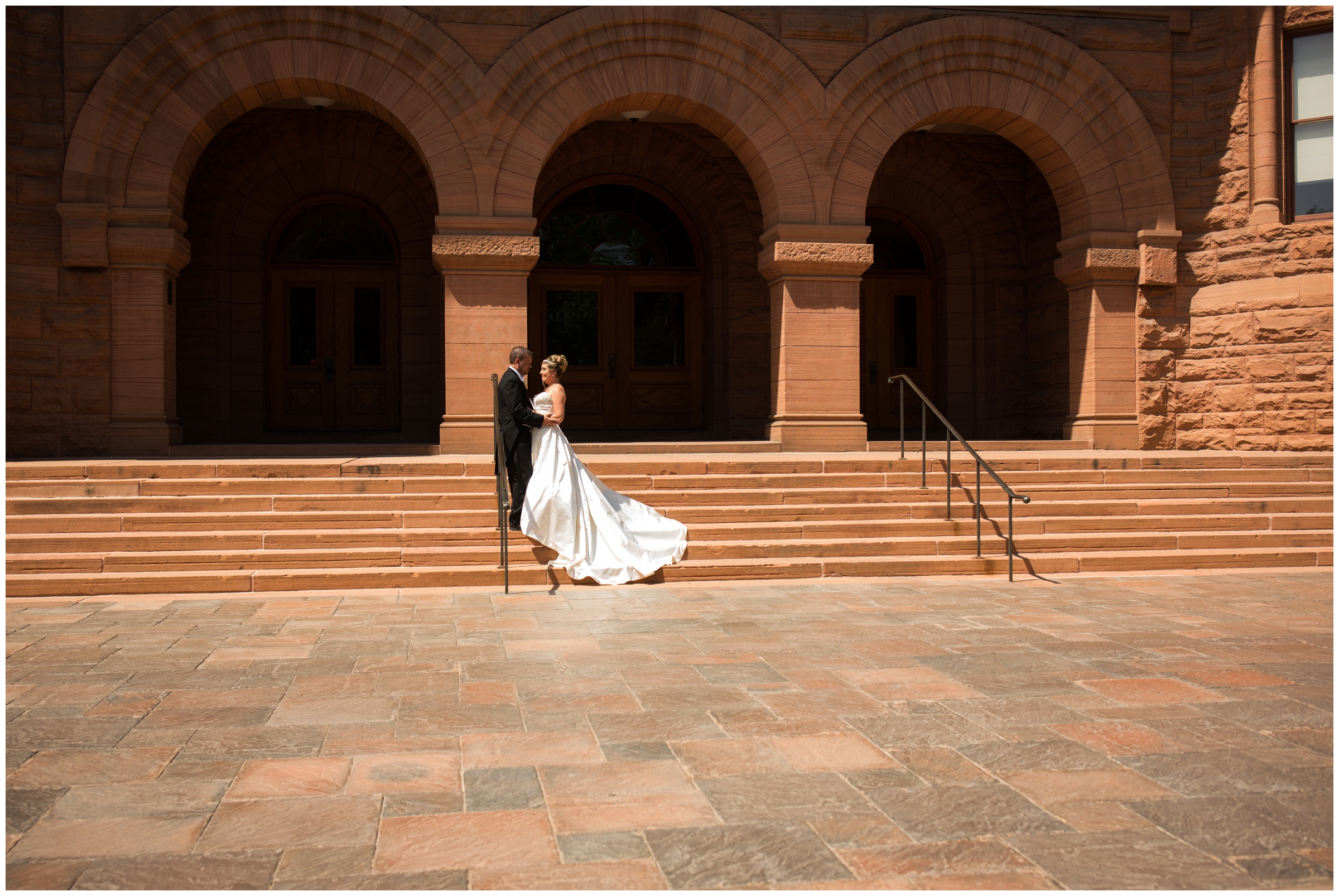 bride and groom posing on stairs during Colorado Springs wedding photos by Plum Pretty Photography 