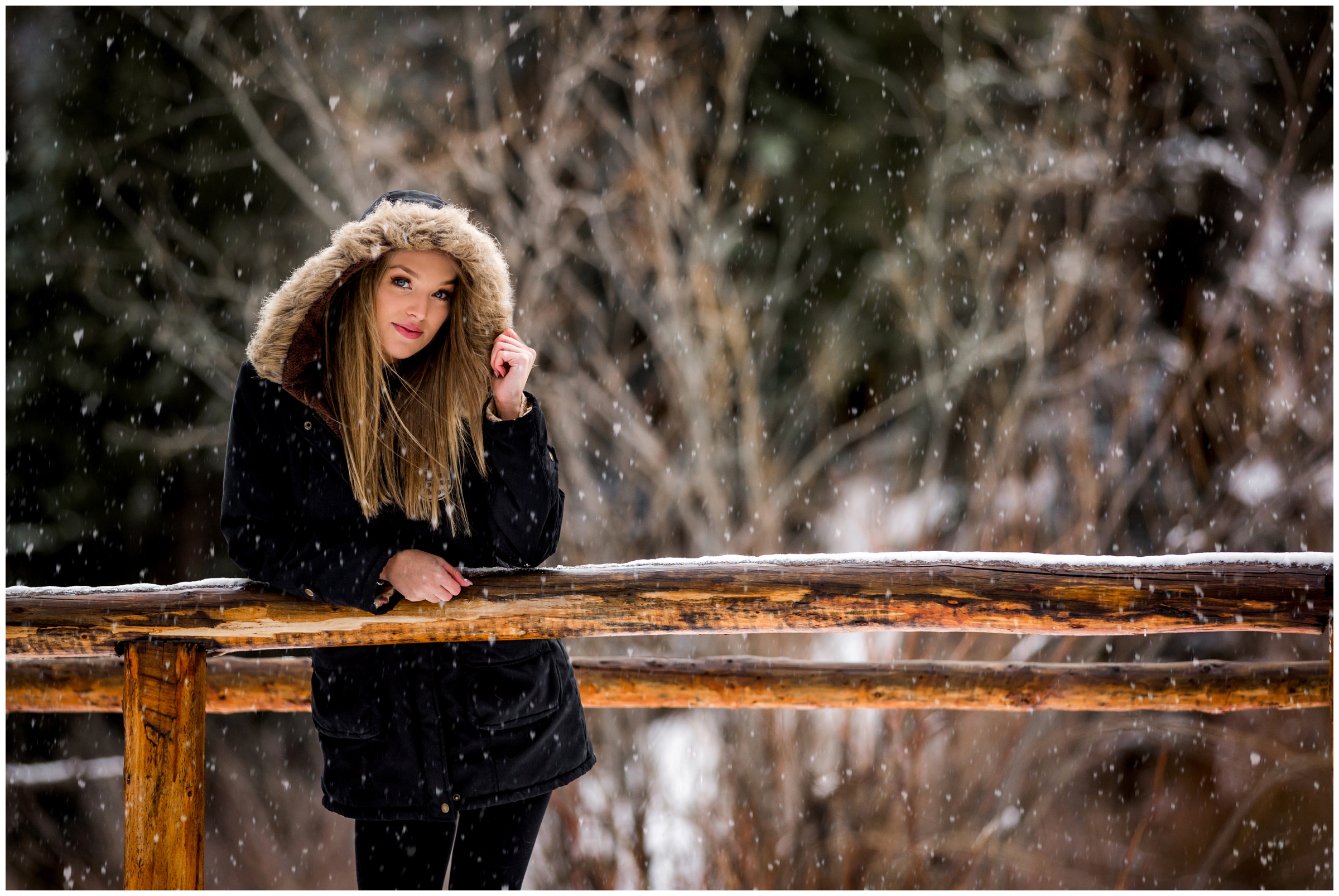teen girl posing on a bridge during snowy Colorado senior photos 