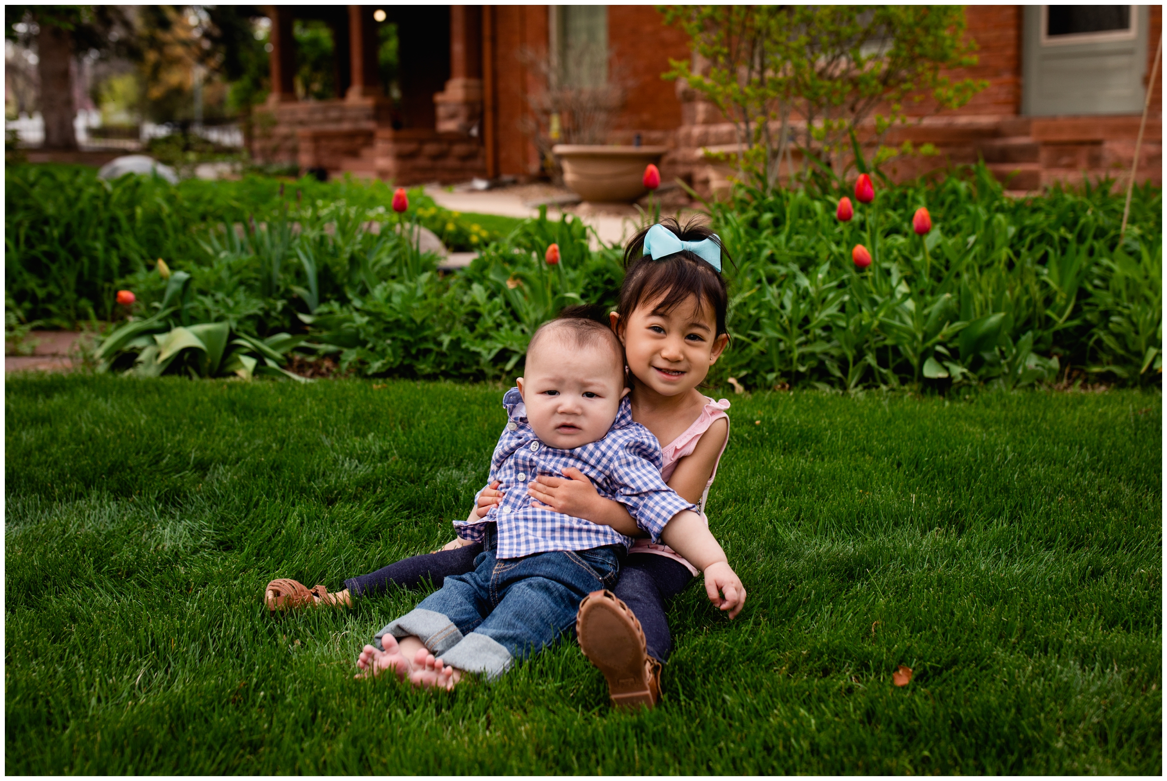 girl holding baby brother during Longmont Colorado family pictures 
