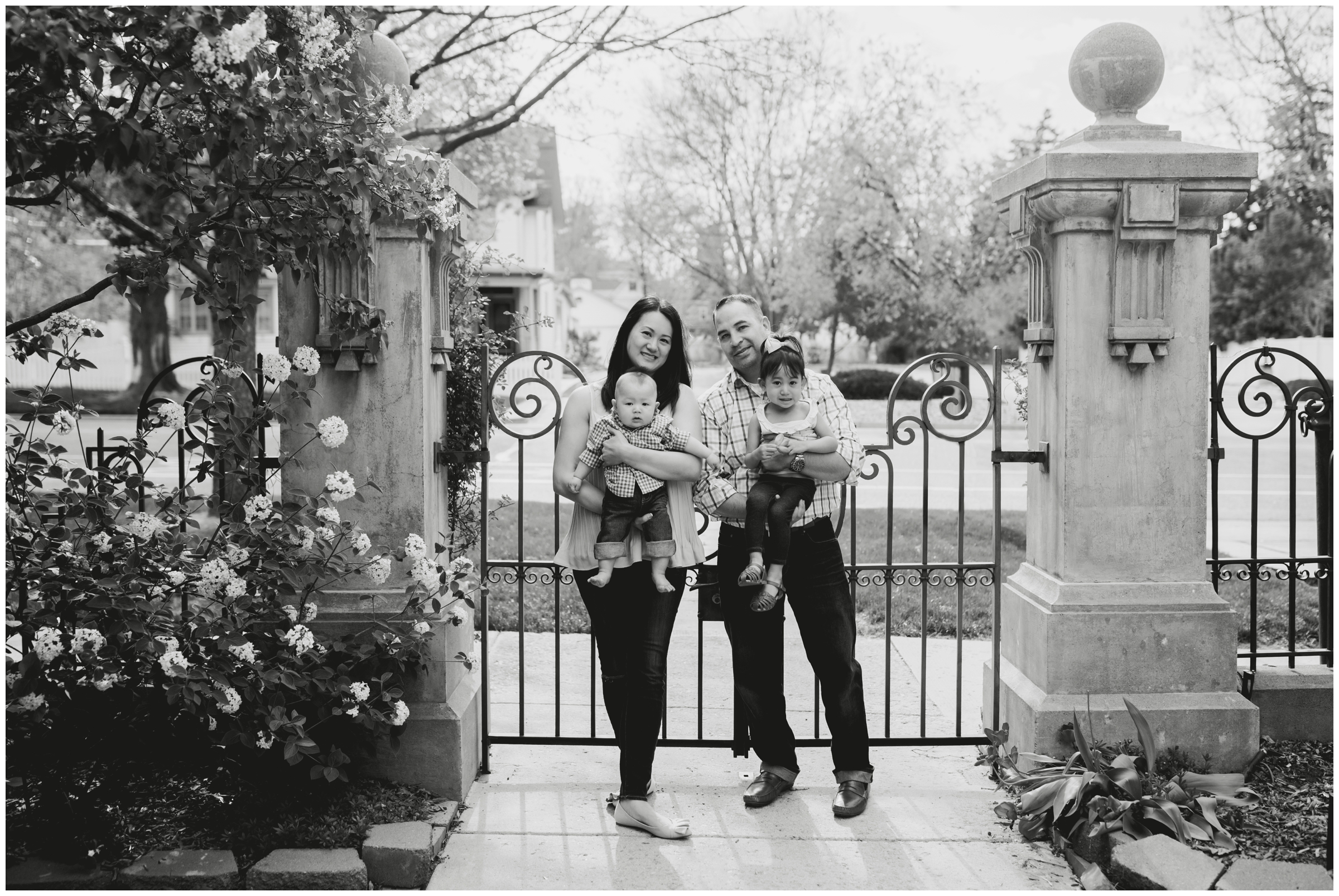 family posing in front of wrought iron gates at Longmont Colorado family photographs