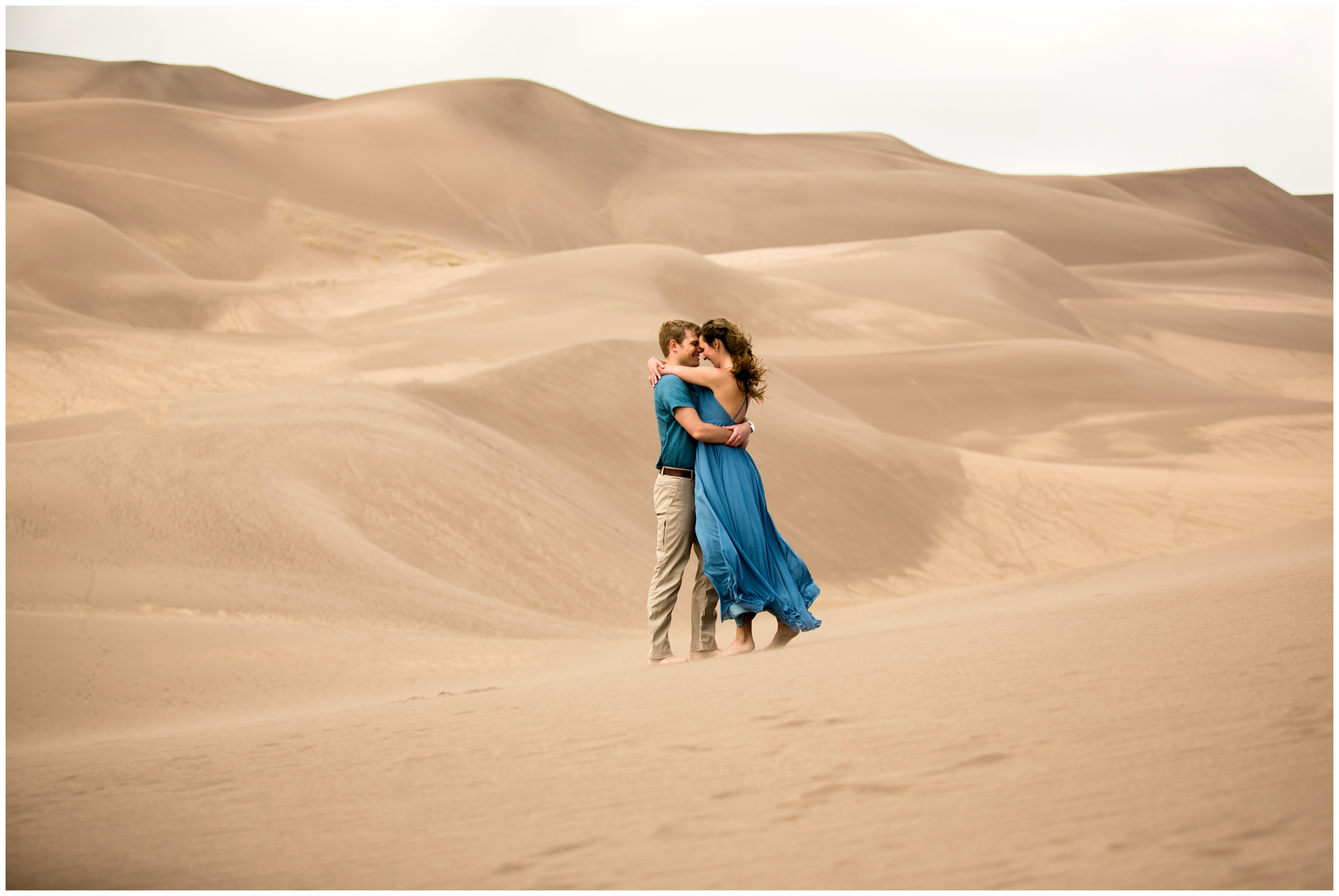 couple embracing at the Great Sand Dunes National Park during Colorado anniversary photos 
