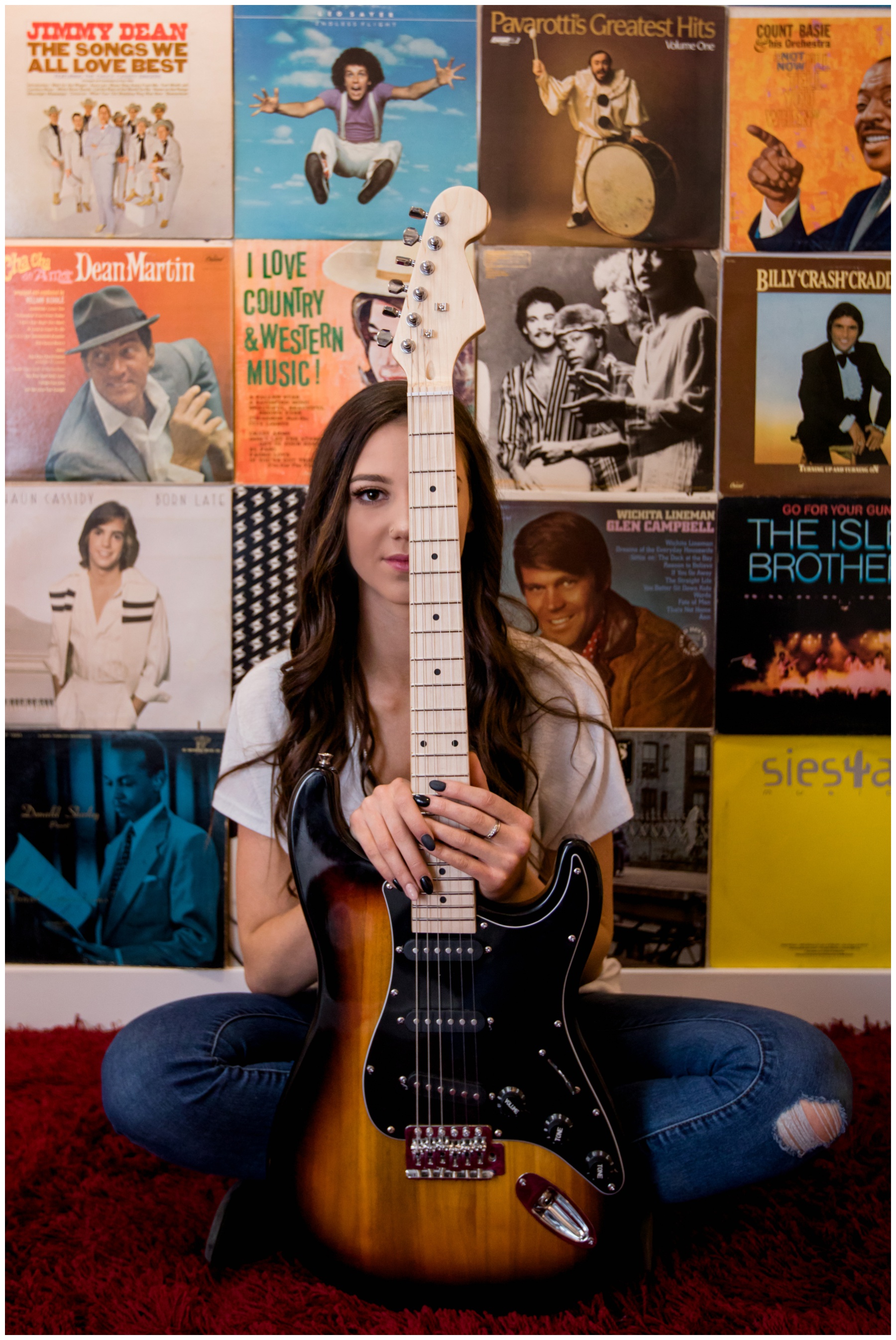 teen holding guitar during urban senior portraits in Boulder Colorado 
