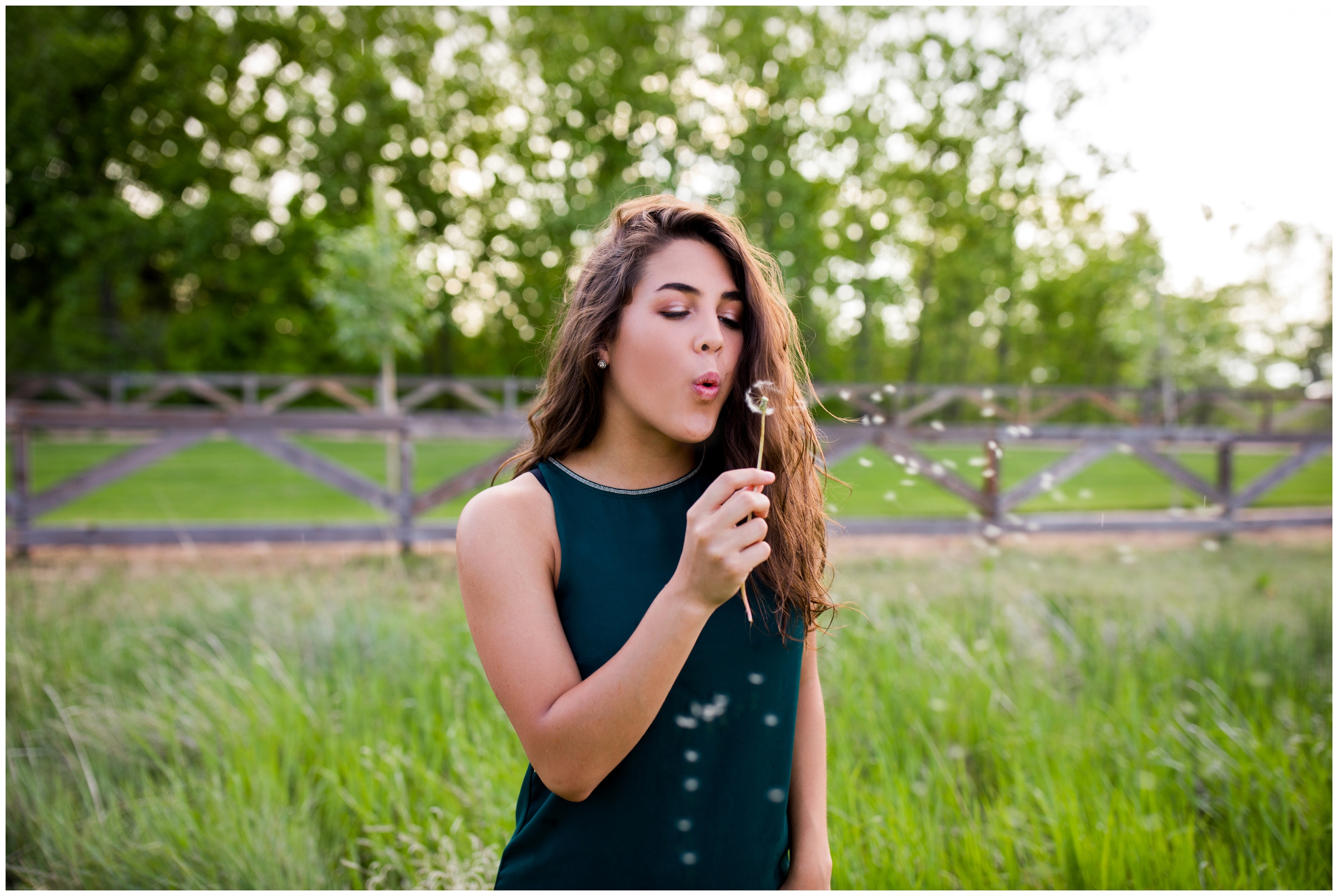 teen girl blowing dandelion during Erie Colorado senior pictures  