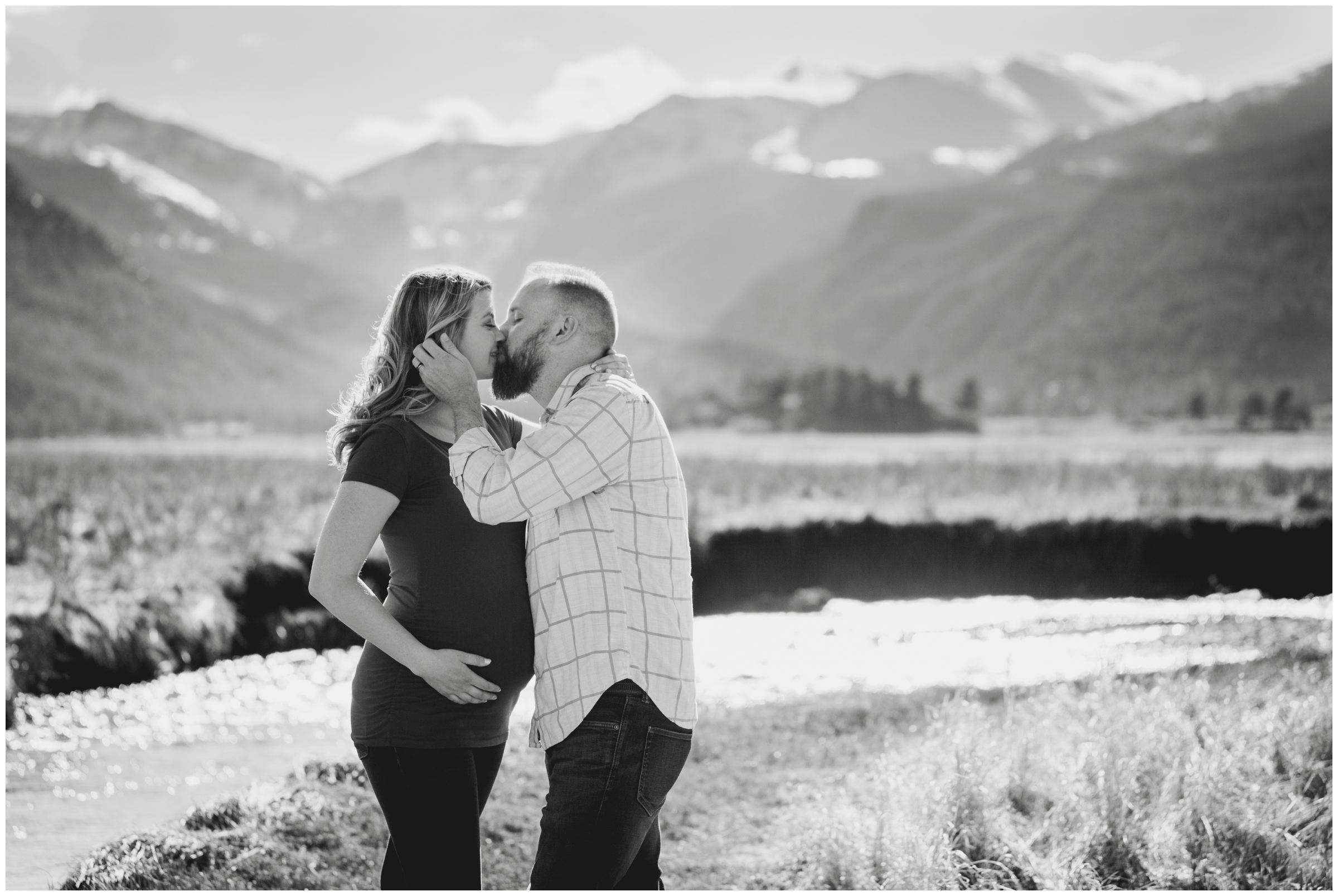 couple kissing with mountains in background during Colorado engagement photography session 