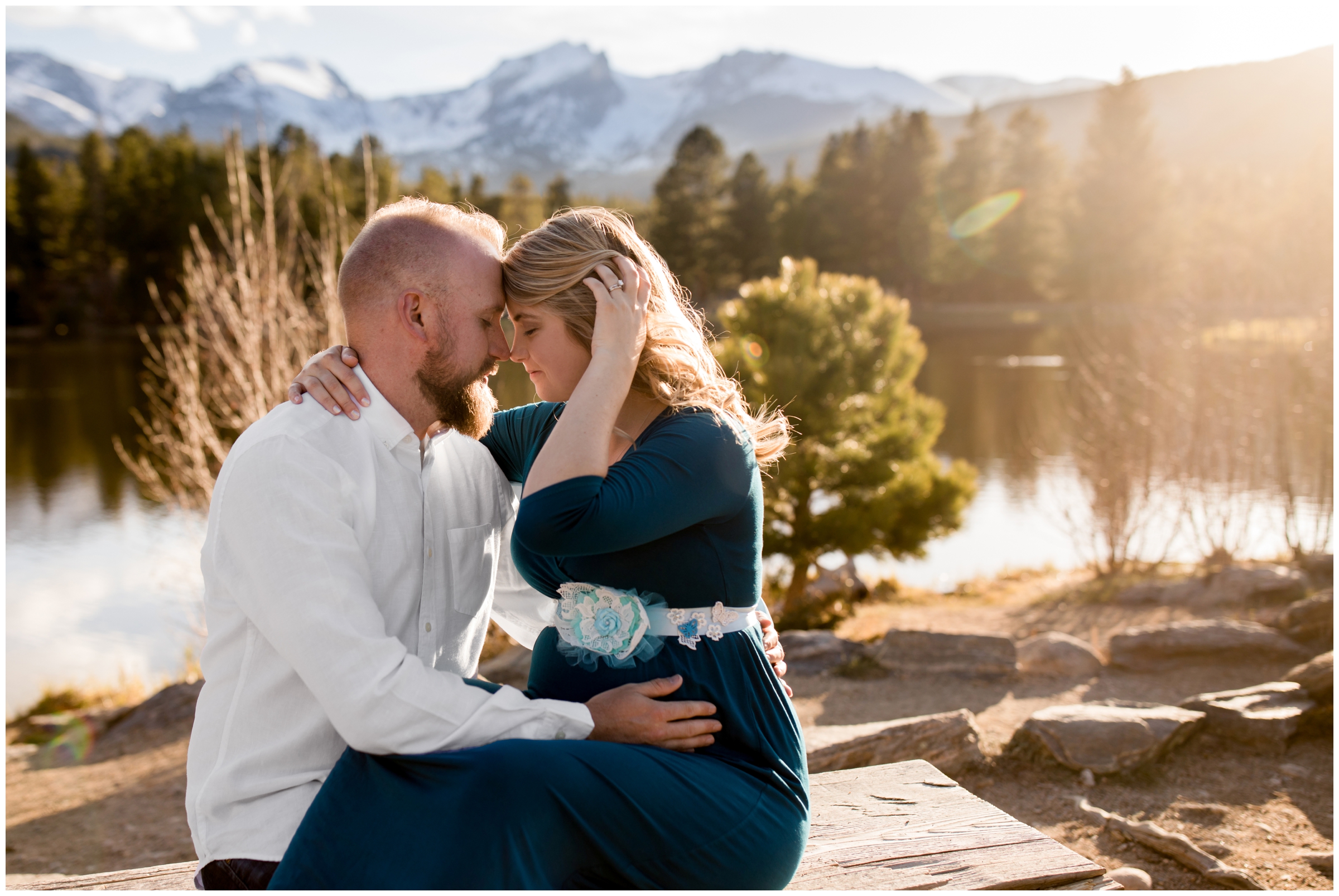 couple sitting on bench during Estes Park maternity photos in Rocky Mountain National Park by Colorado portrait photographer Plum Pretty Photography