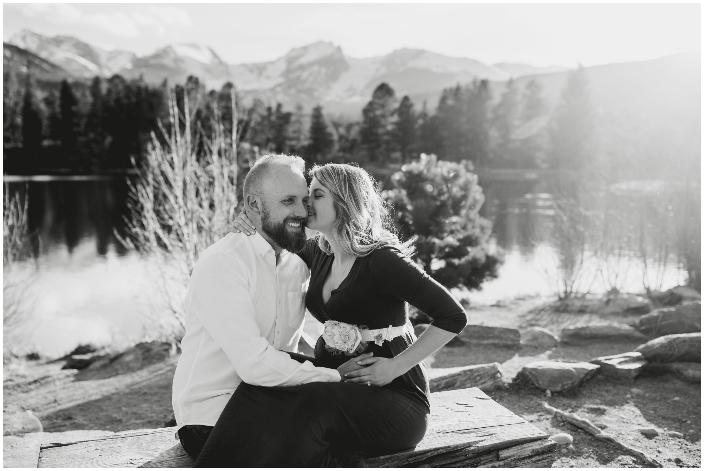 pregnant woman kissing husband during Colorado lake maternity portraits 