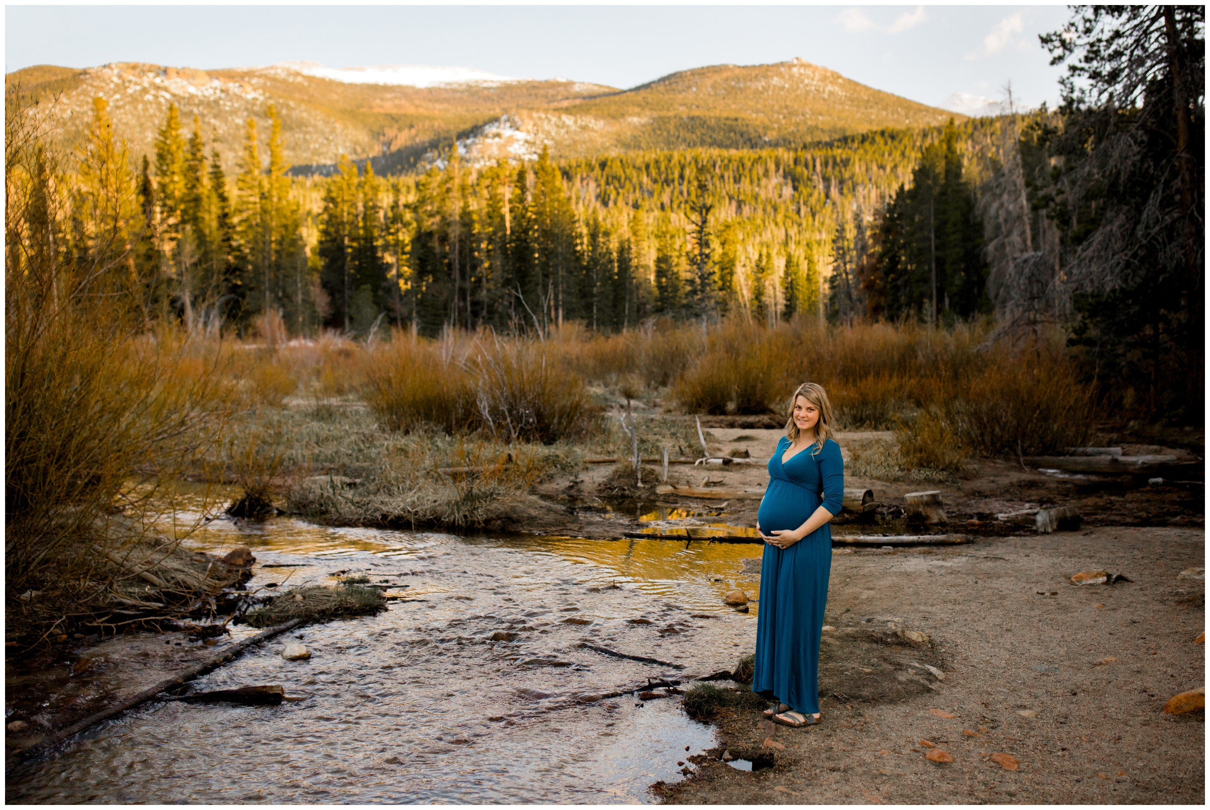 pregnant woman standing next to creek during Colorado mountain maternity pictures 