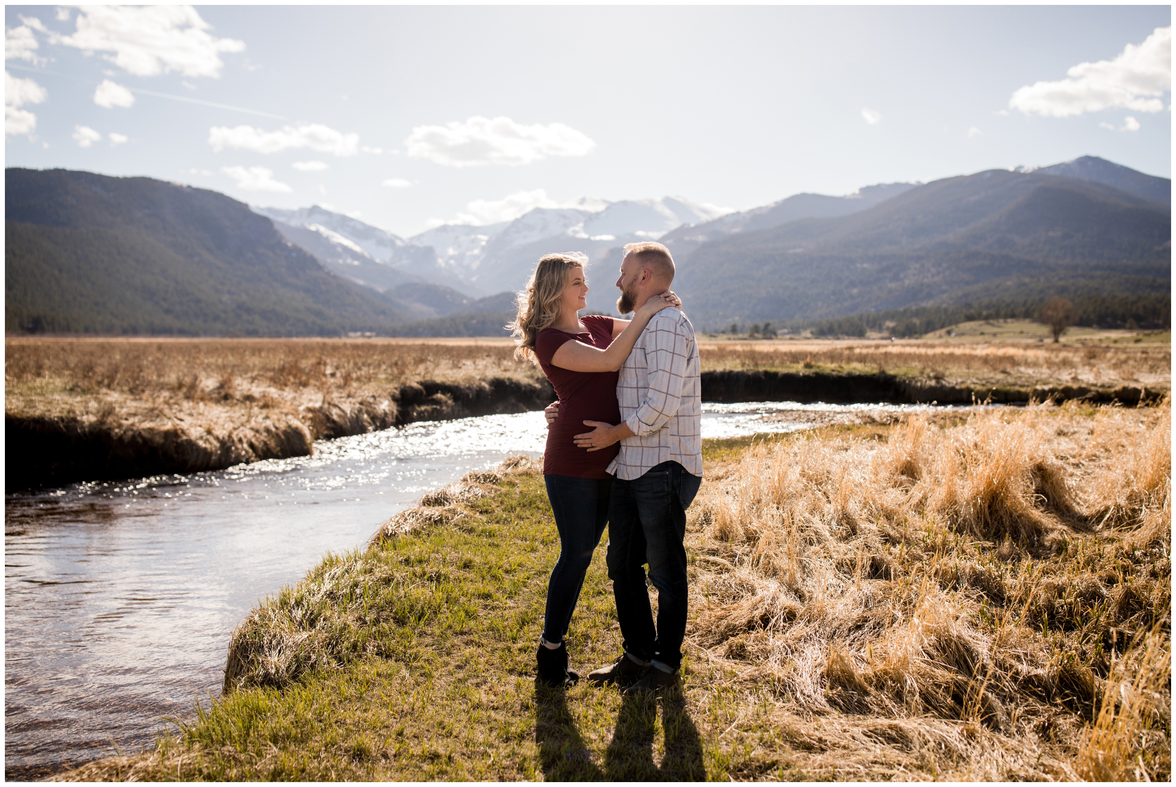 couple embracing during Colorado mountain maternity pictures at Moraine Park 