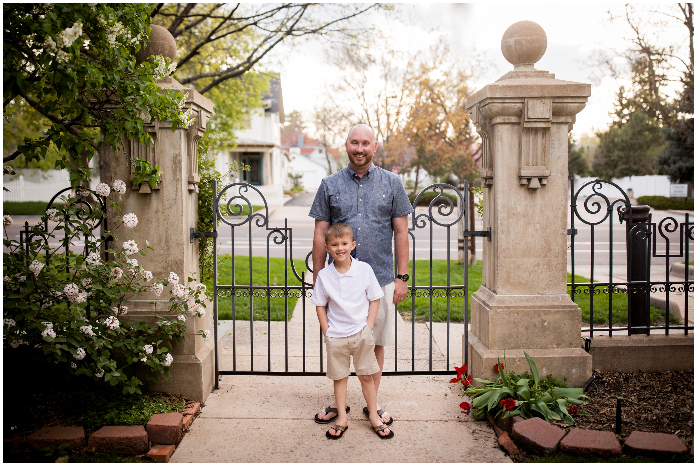 father and son posing in front of wrought iron gate at Callahan House Longmont family photos 