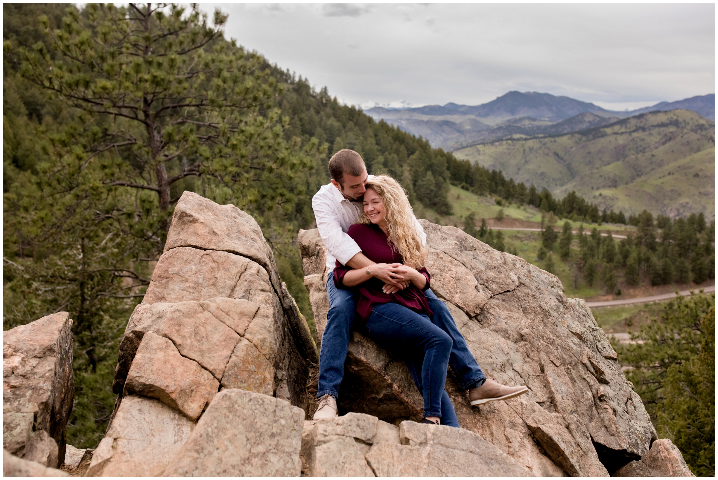 couple cuddling on rocks during Colorado mountain engagement portraits 