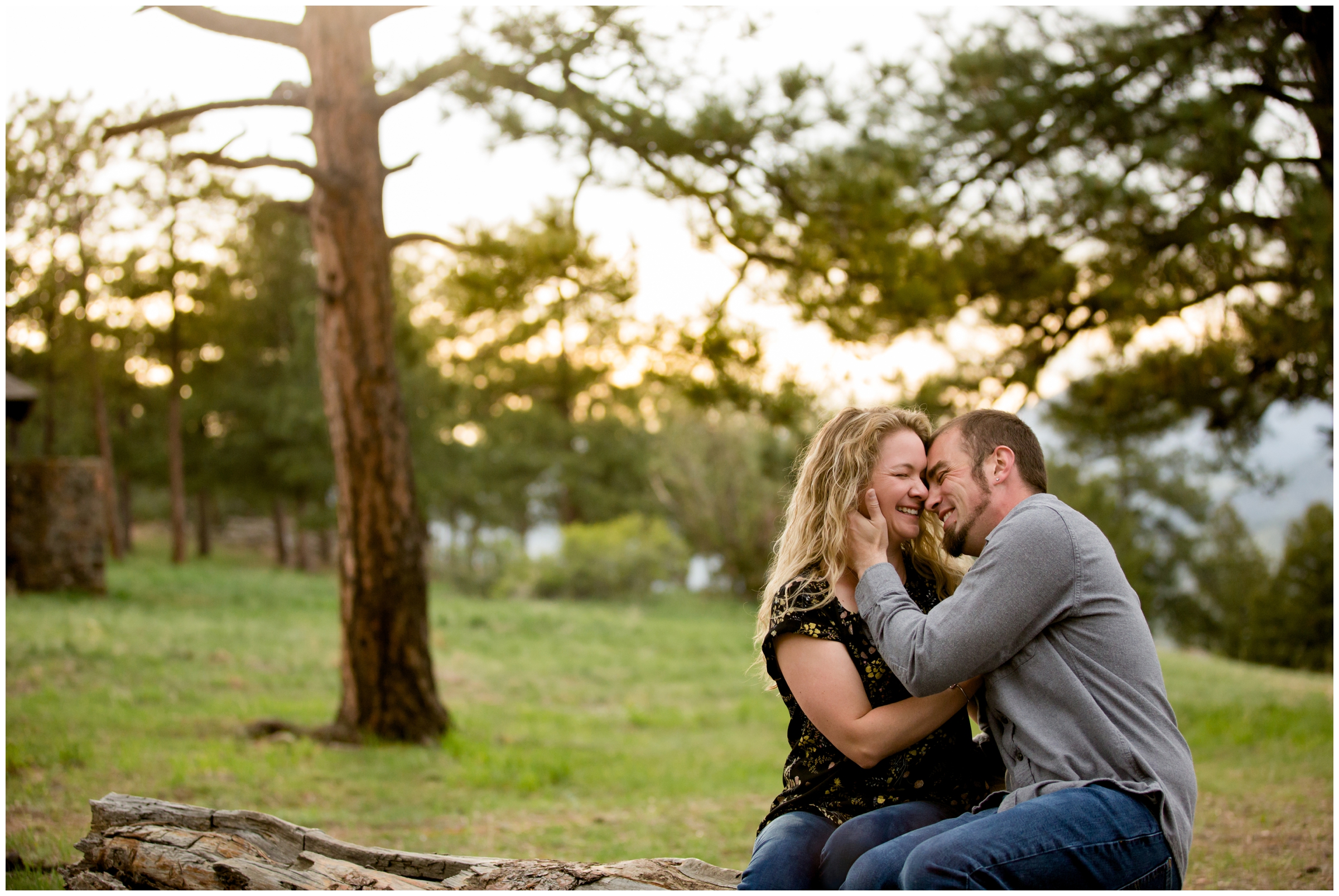 couple snuggling on log during Golden Colorado engagement portraits on Lookout Mountain 