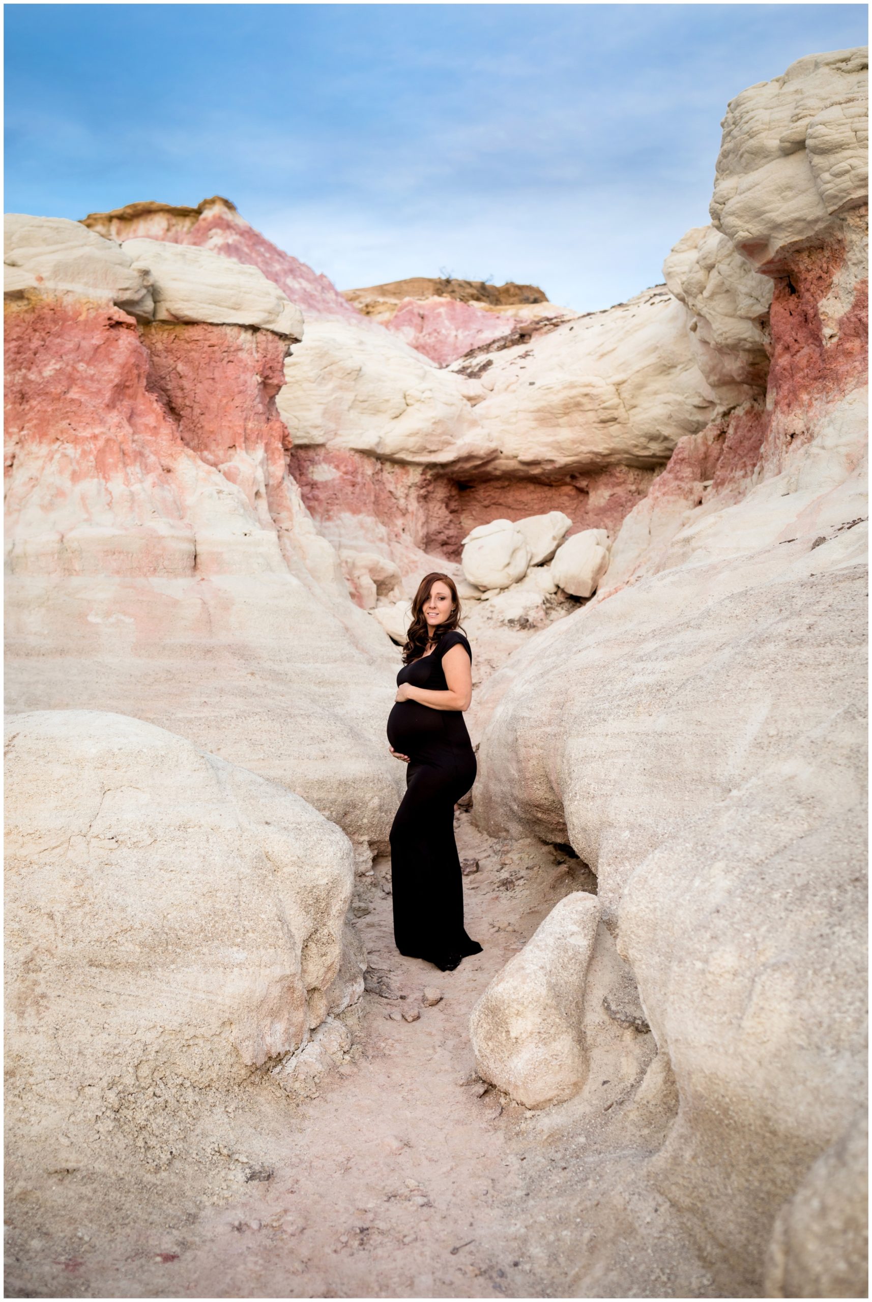pregnant woman holding her belly during Colorado maternity photographs