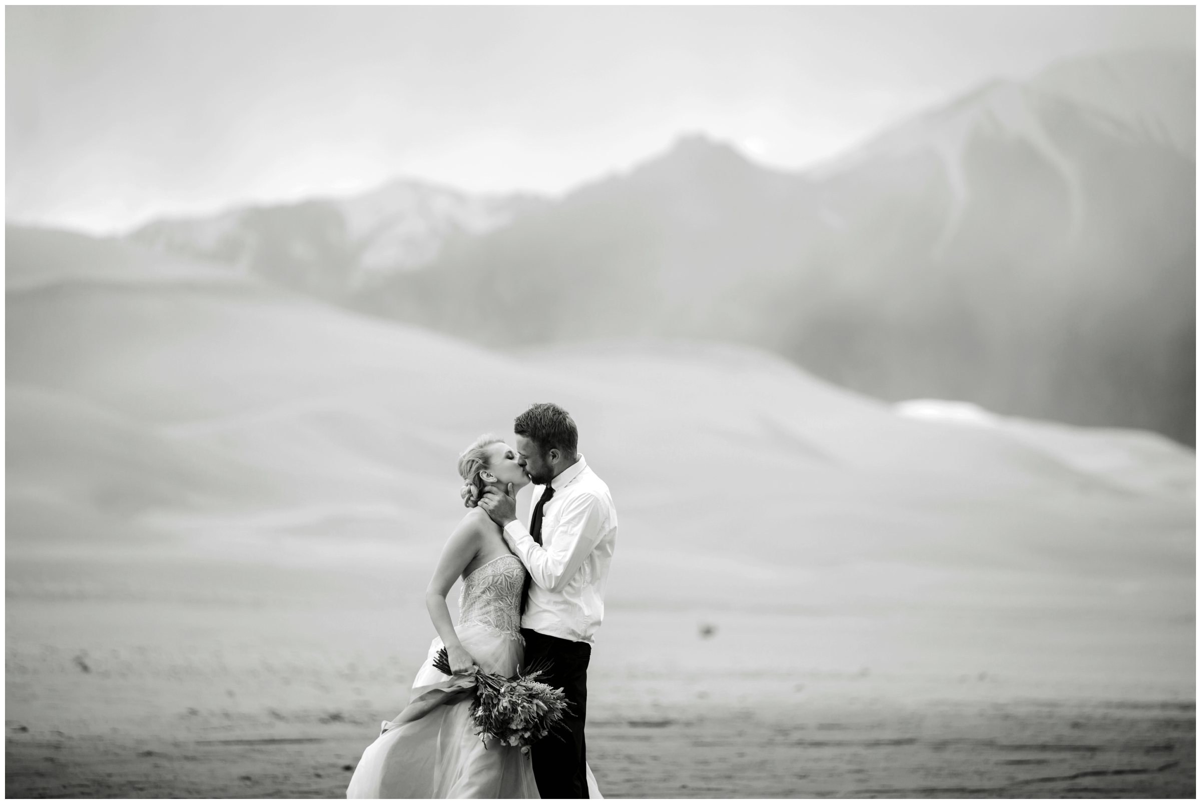 couple kissing with mountains in background at Colorado elopement wedding 