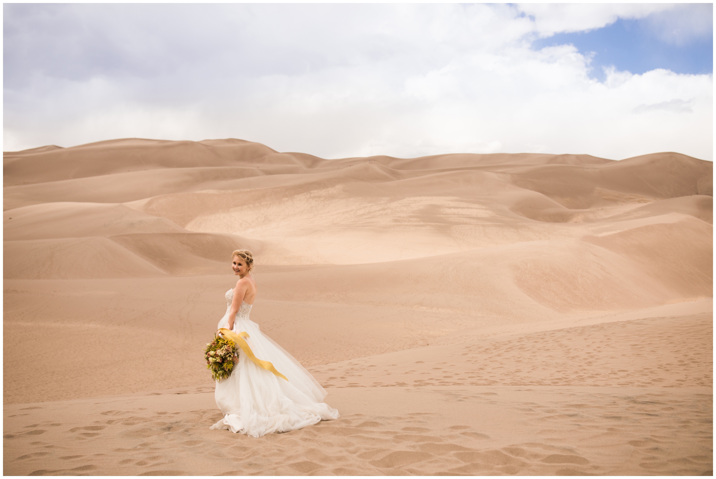 bride with yellow bouquet posing at Great Sand Dunes National Park Colorado elopement 