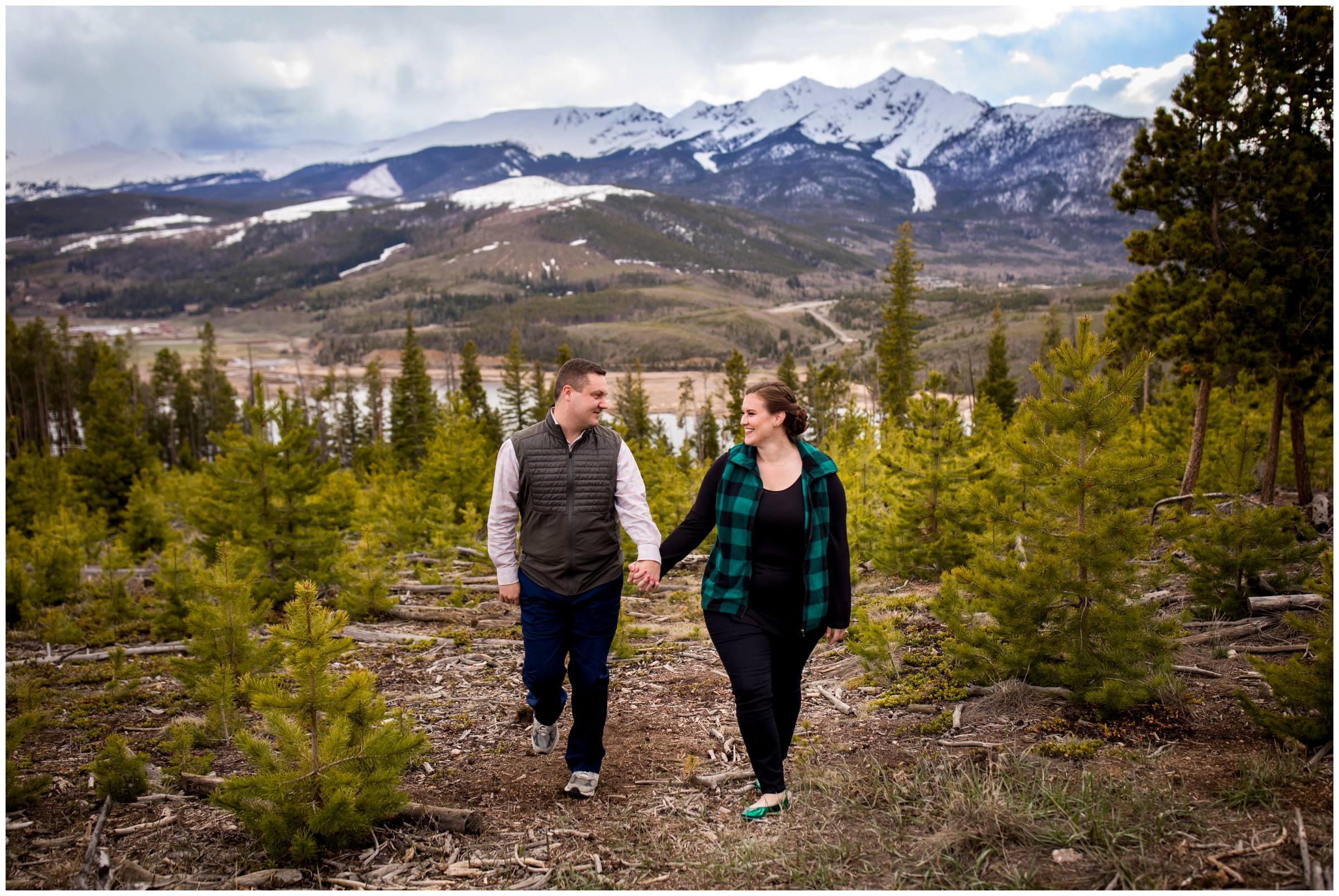 couple walking with mountains in background during Sapphire Point engagement pictures 