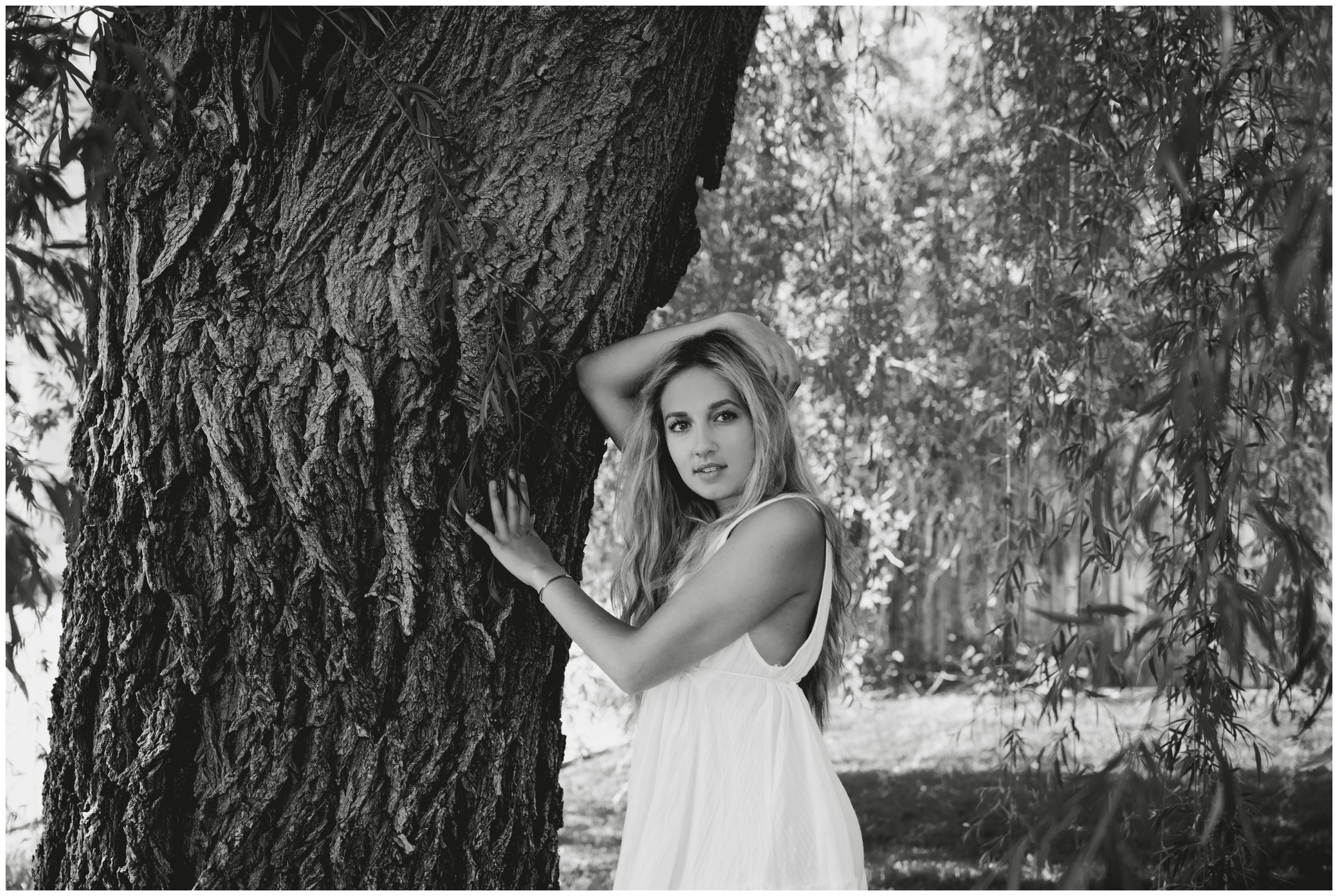 teen girl leaning against tree during Broomfield Colorado senior pictures 