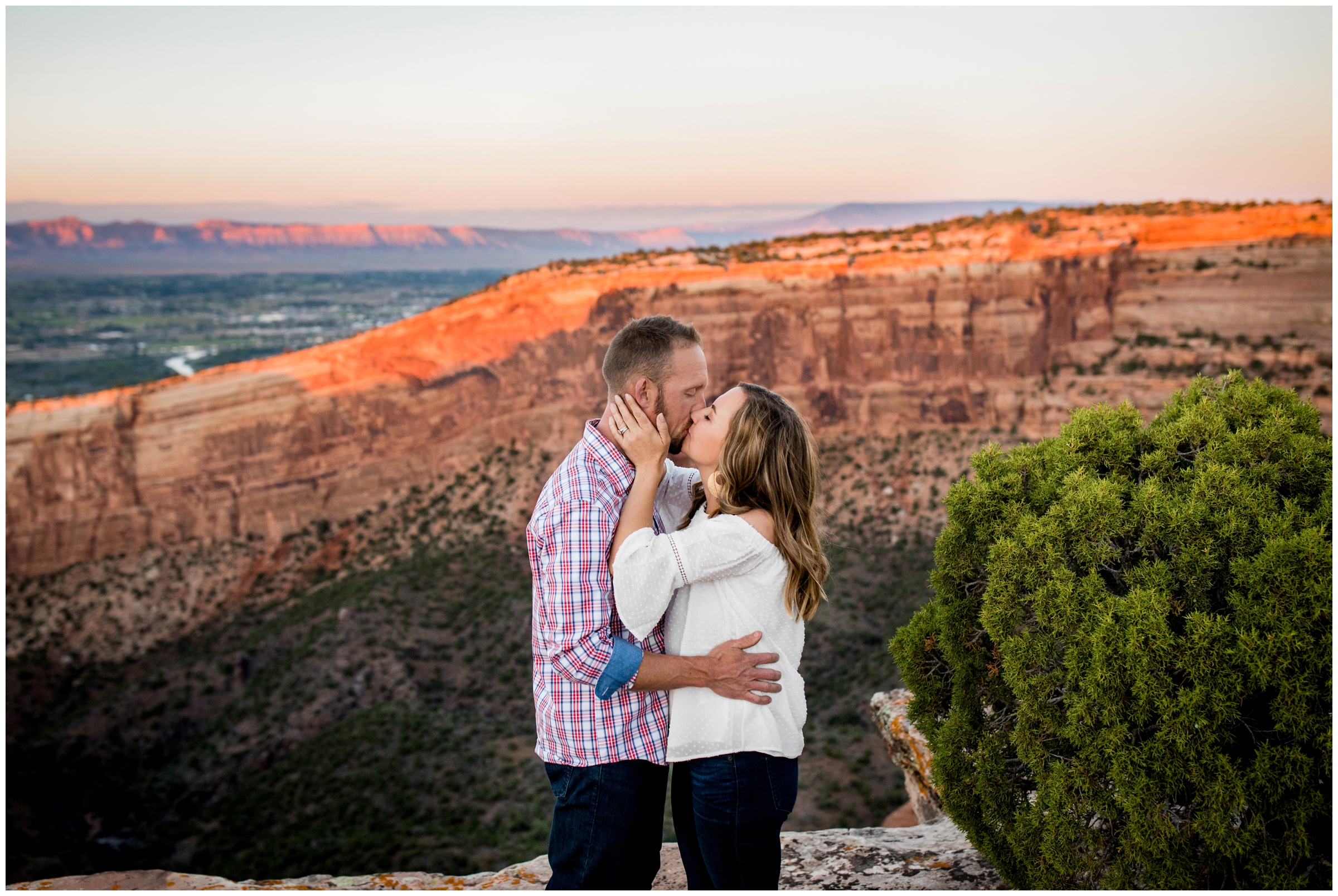 couple kissing on Colorado National Monument during Grand Junction mountain engagement photos 