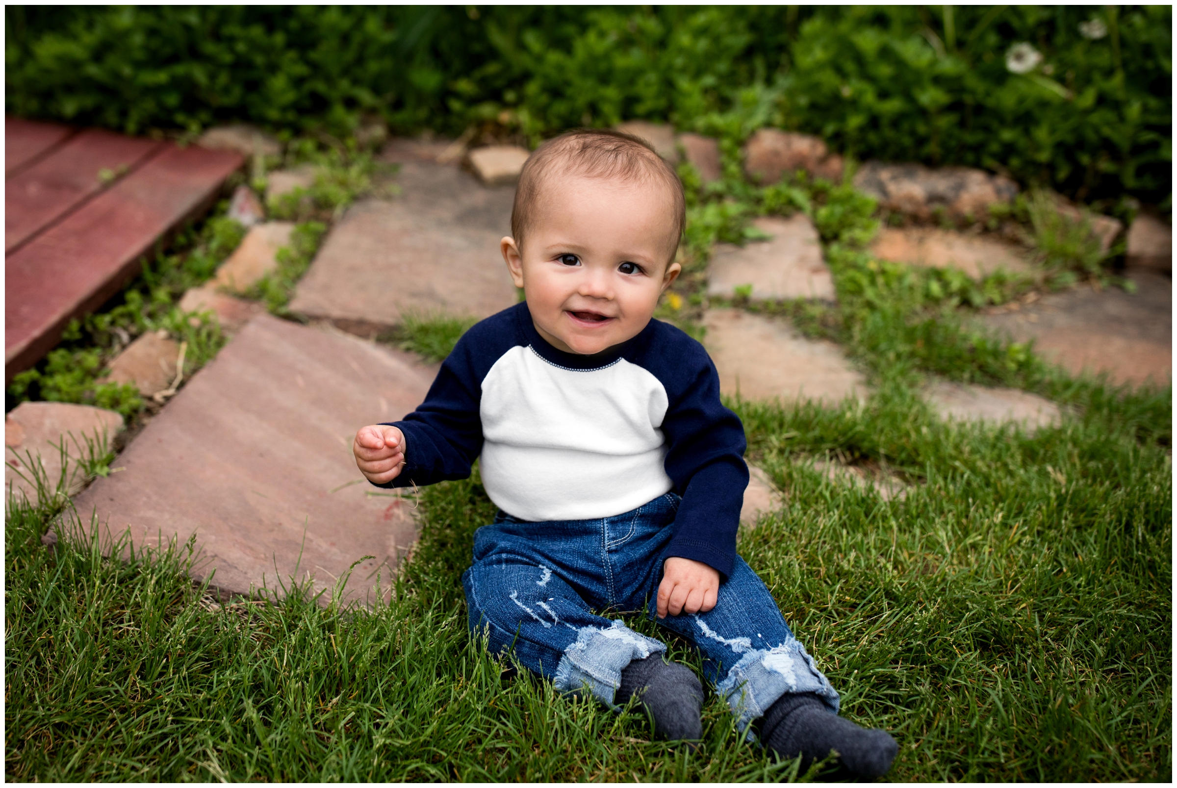 baby boy sitting in grass at Old Mill Park Colorado 