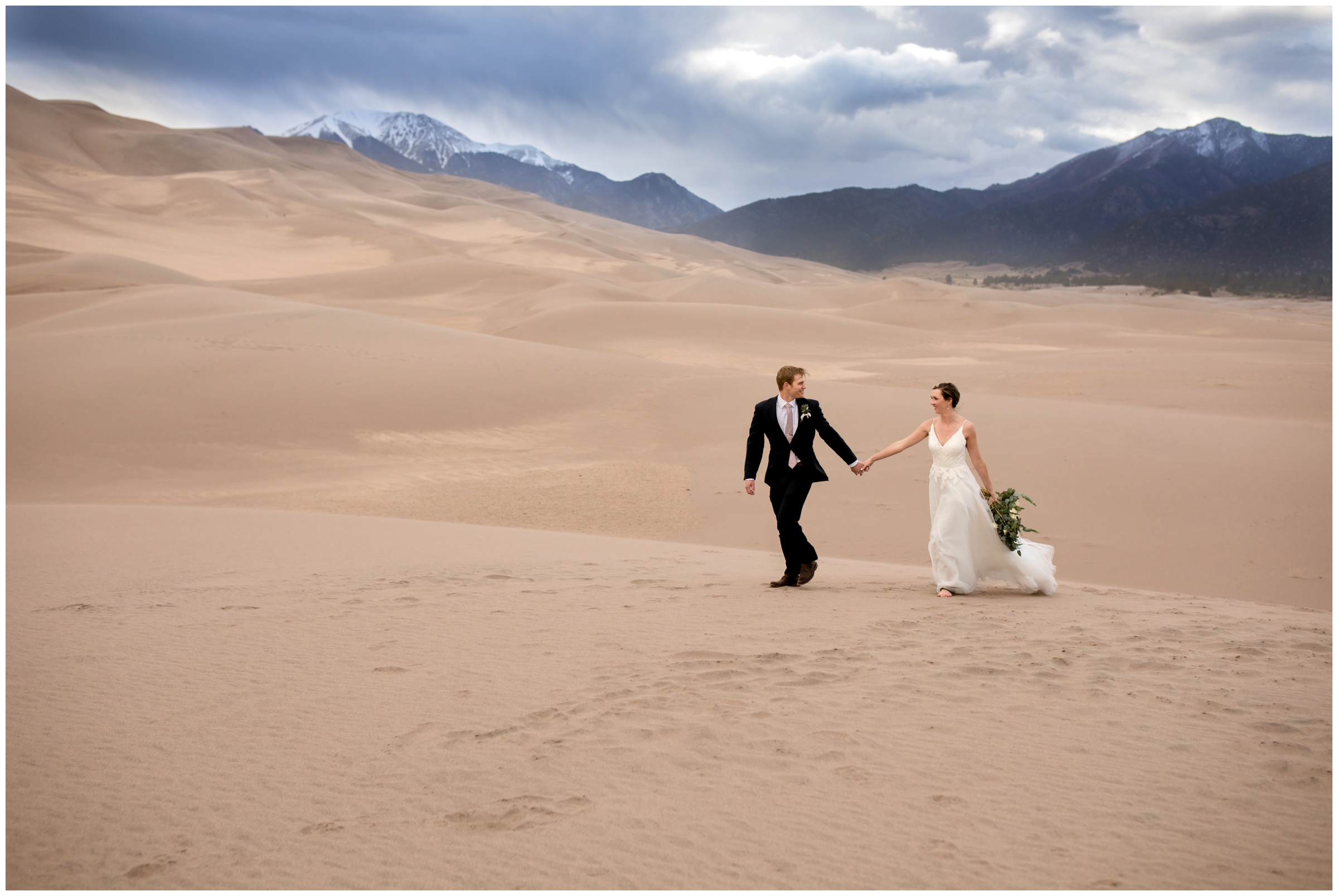 couple walking during Great Sand Dunes Colorado wedding by CO elopement photographer Plum Pretty Photography
