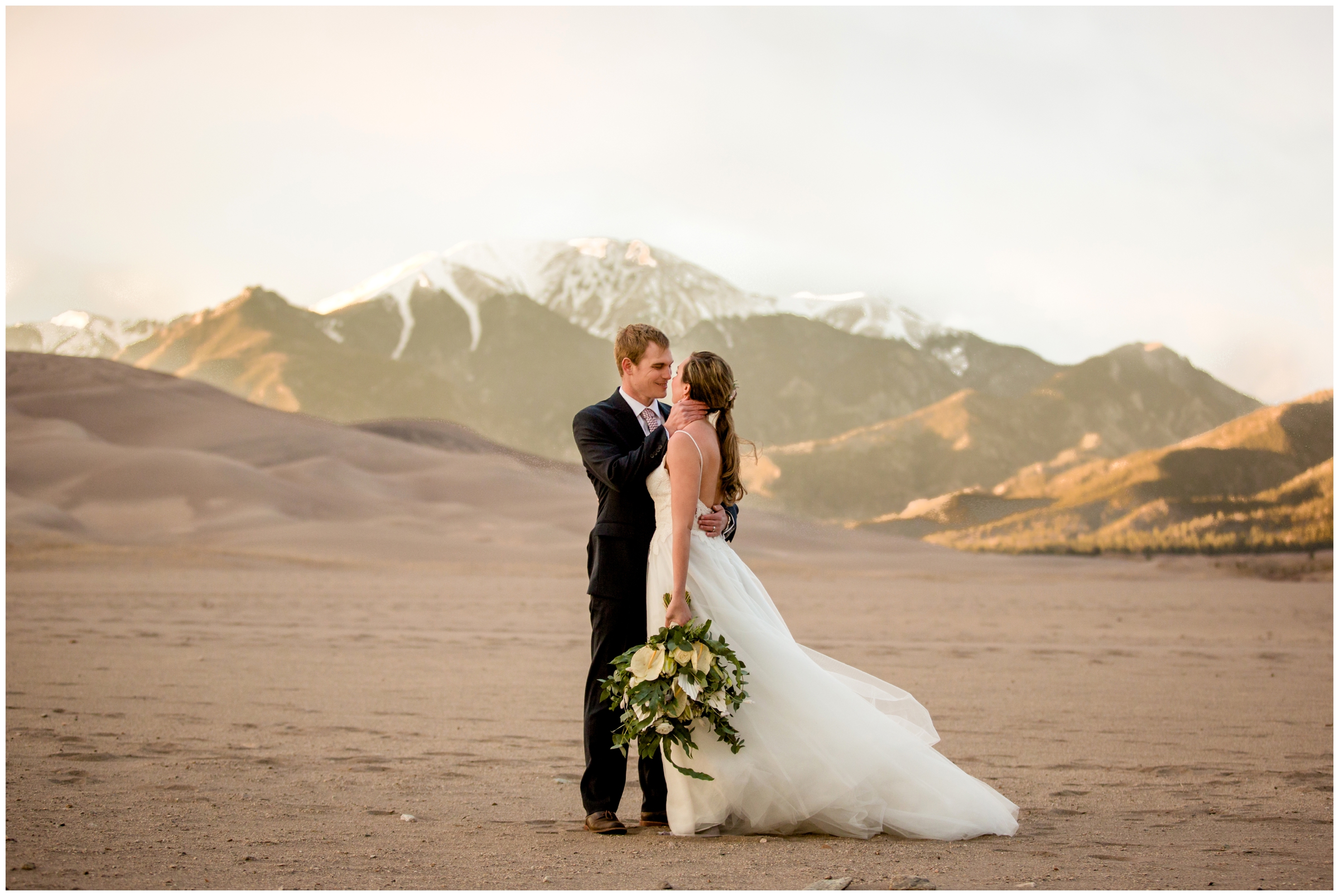 couple kissing with mountains in background at Southern Colorado adventure elopement 